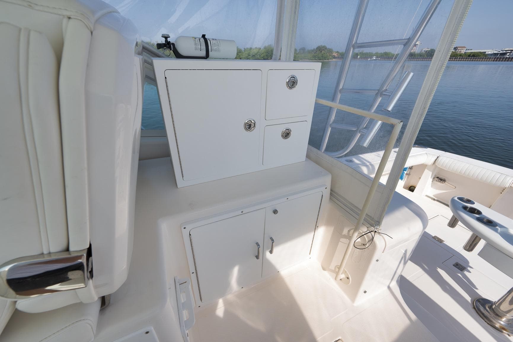 2006 Cabo 32 Express boat interior with storage cabinets and seating area.