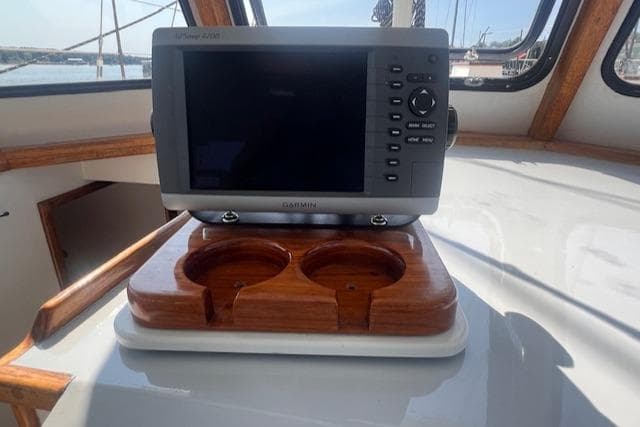 Cockpit of 1996 Custom Bolger PH Shoal-draft Ketch with navigation system and cup holders.