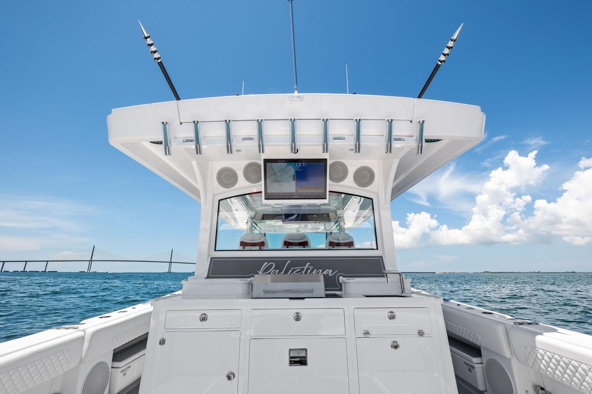 2025 HCB 48 Campeon boat interior with fishing rods, ocean view, and clear blue sky.