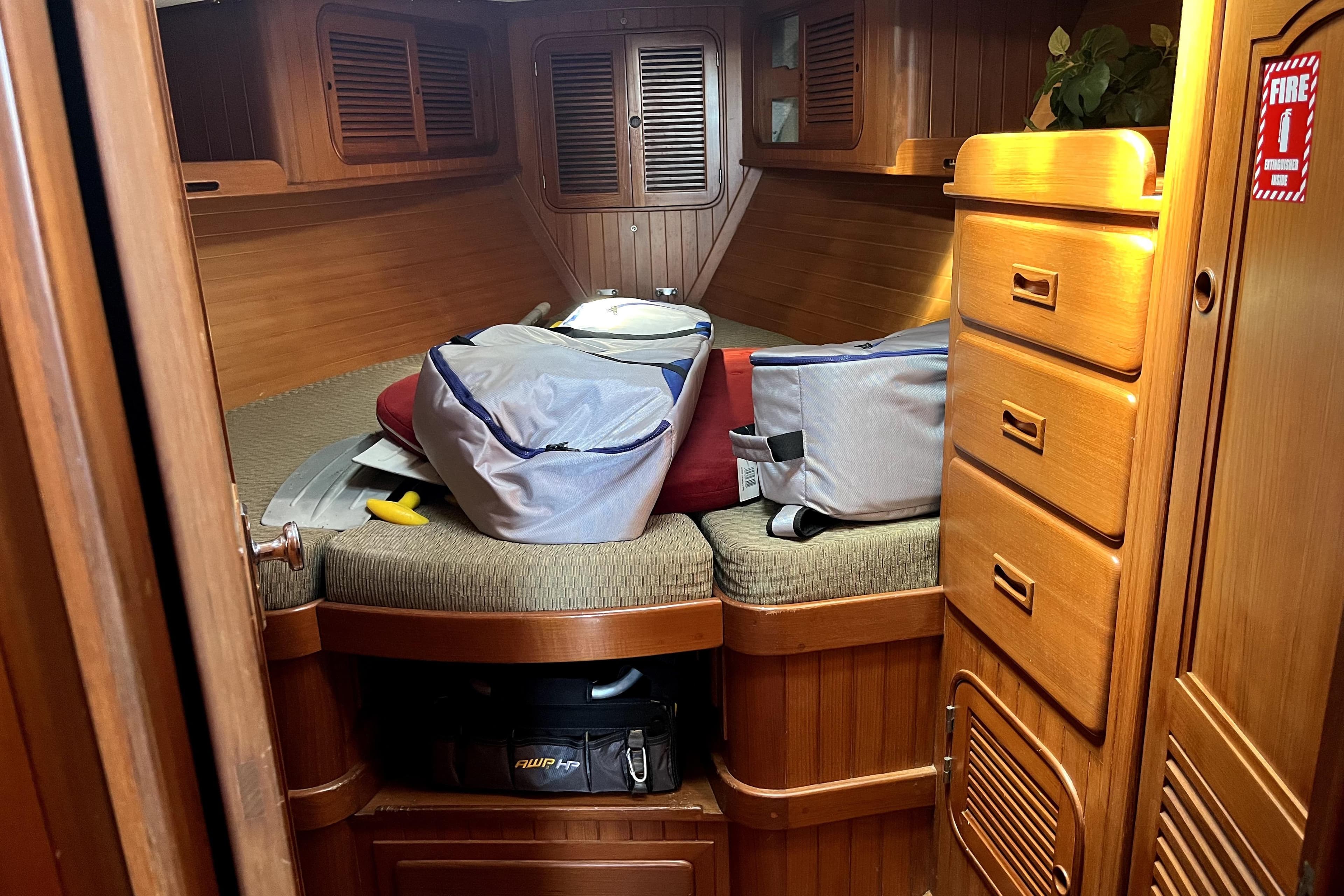 Cozy cabin interior of a 1985 Baba 40 Pilot House sailboat with wooden furnishings.