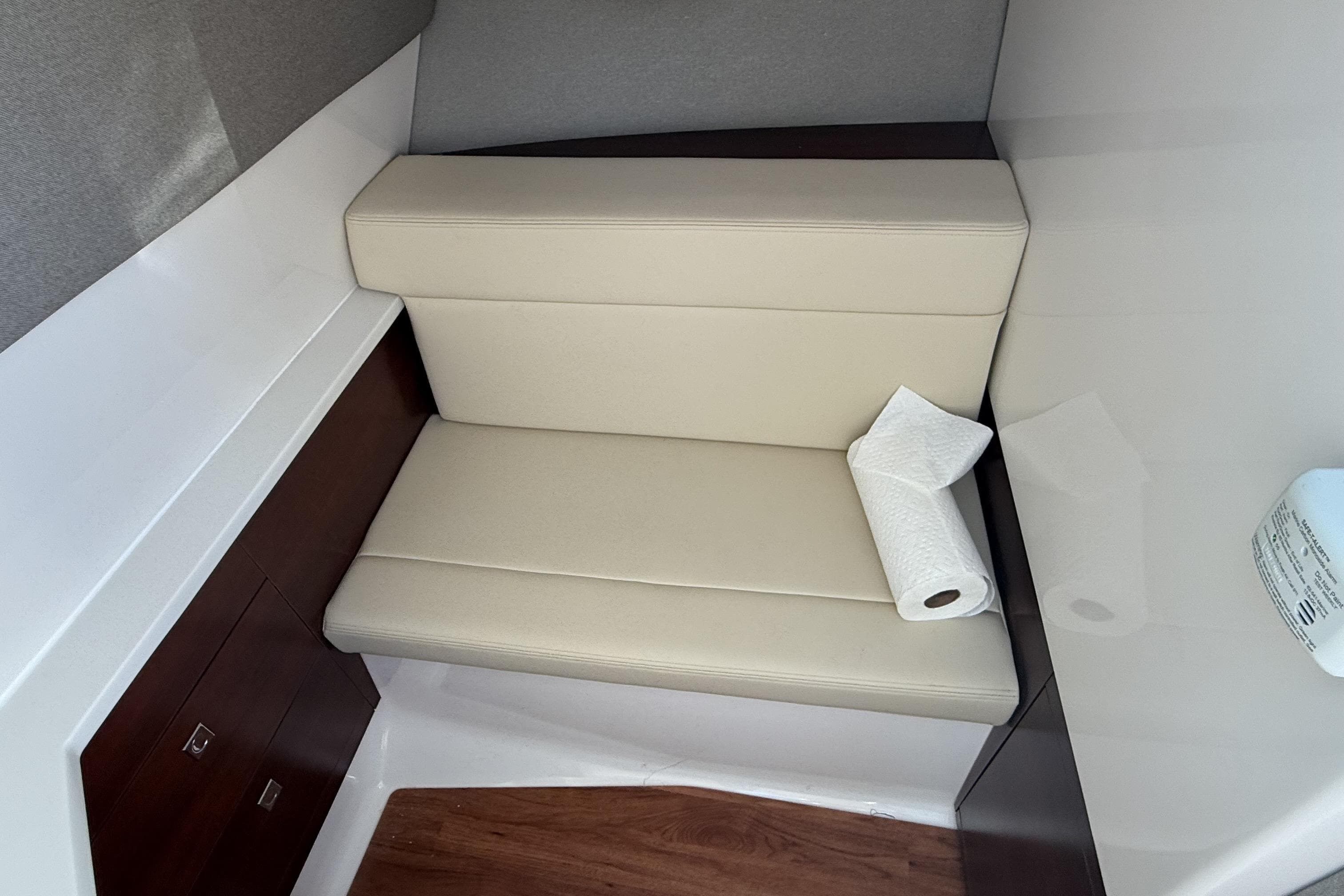 2025 Chaparral 280 OSX cabin interior with beige seating and wooden accents.