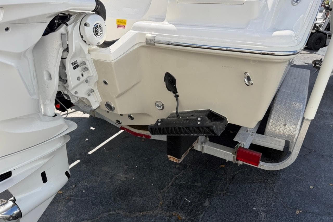 2026 Key West 239 FSR boat on trailer, rear view showing motor and hull details.