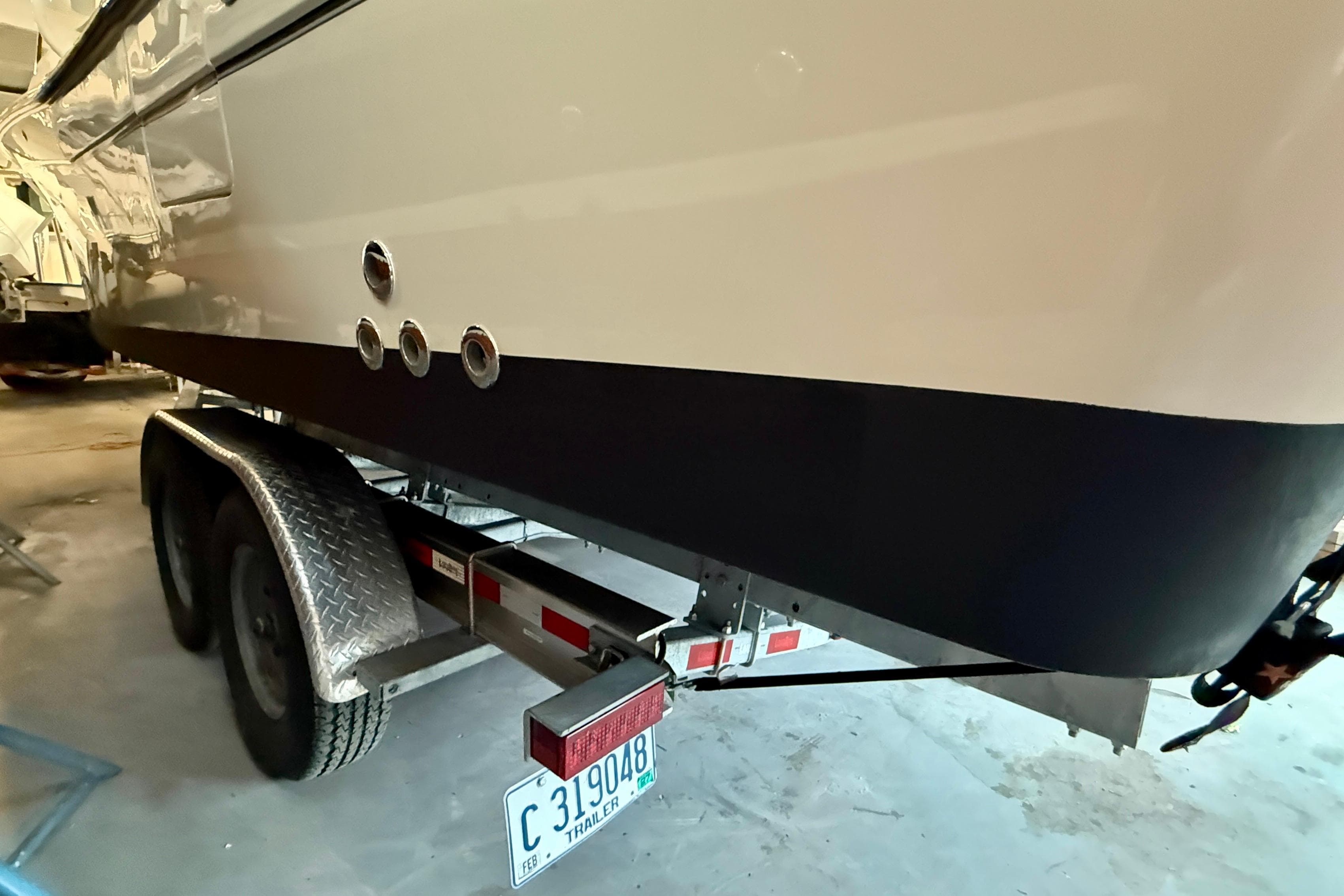 2023 Grady-White Freedom 285 boat on trailer in garage.