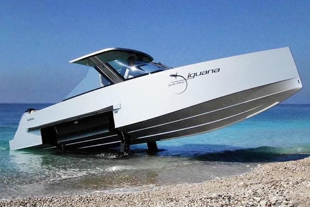 Amphibious IGUANA Yachts 29 on beach, 2019 model, transitioning from water to land.