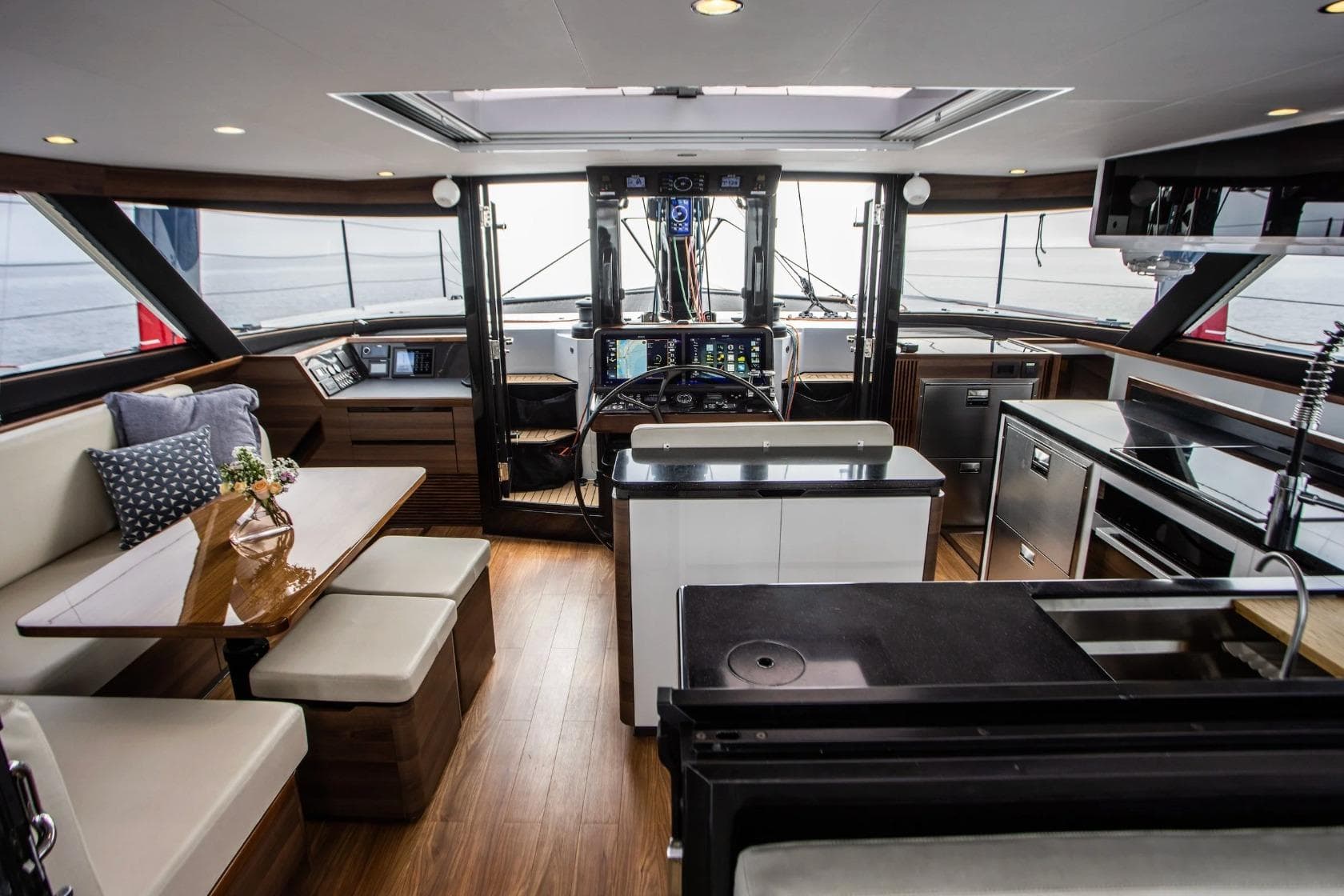 Luxurious interior of 2026 HH Catamarans HH52, featuring modern kitchen and seating area.