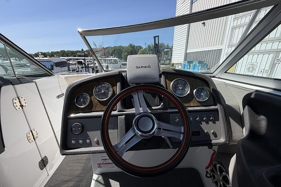Steering wheel and dashboard of a 2010 Cobalt 296 boat with Garmin navigation.