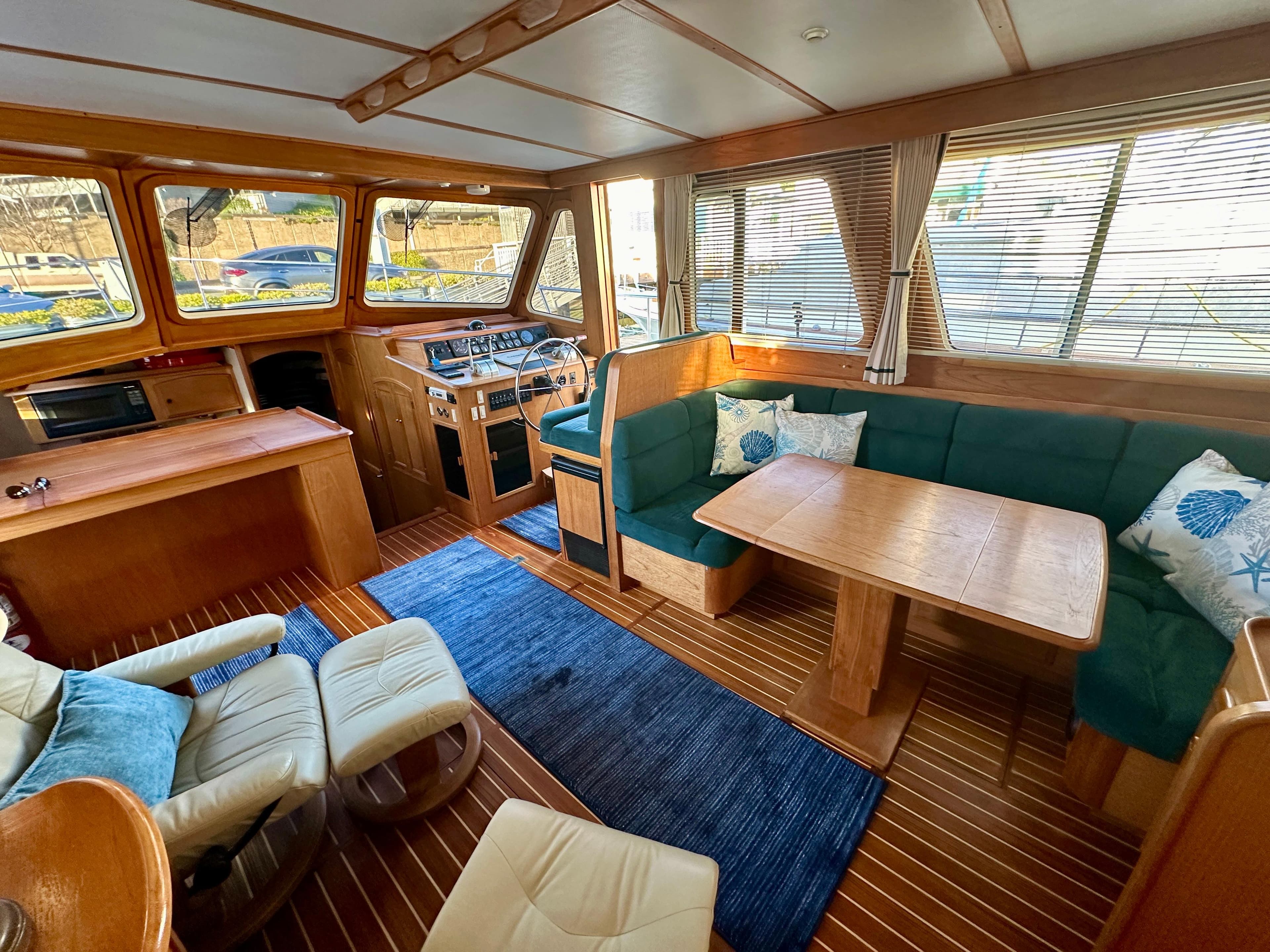 Interior of 1997 Sabre Cockpit Motor Yacht with wood finish and green seating.