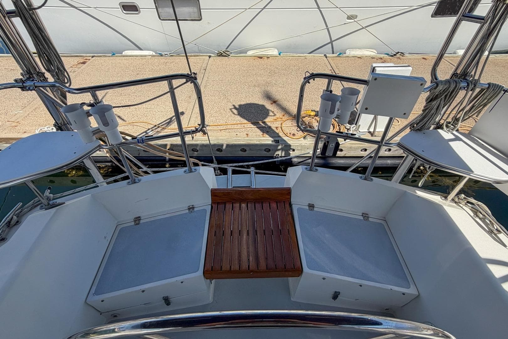Cockpit view of a 1993 Catalina 42 sailboat docked at a marina.