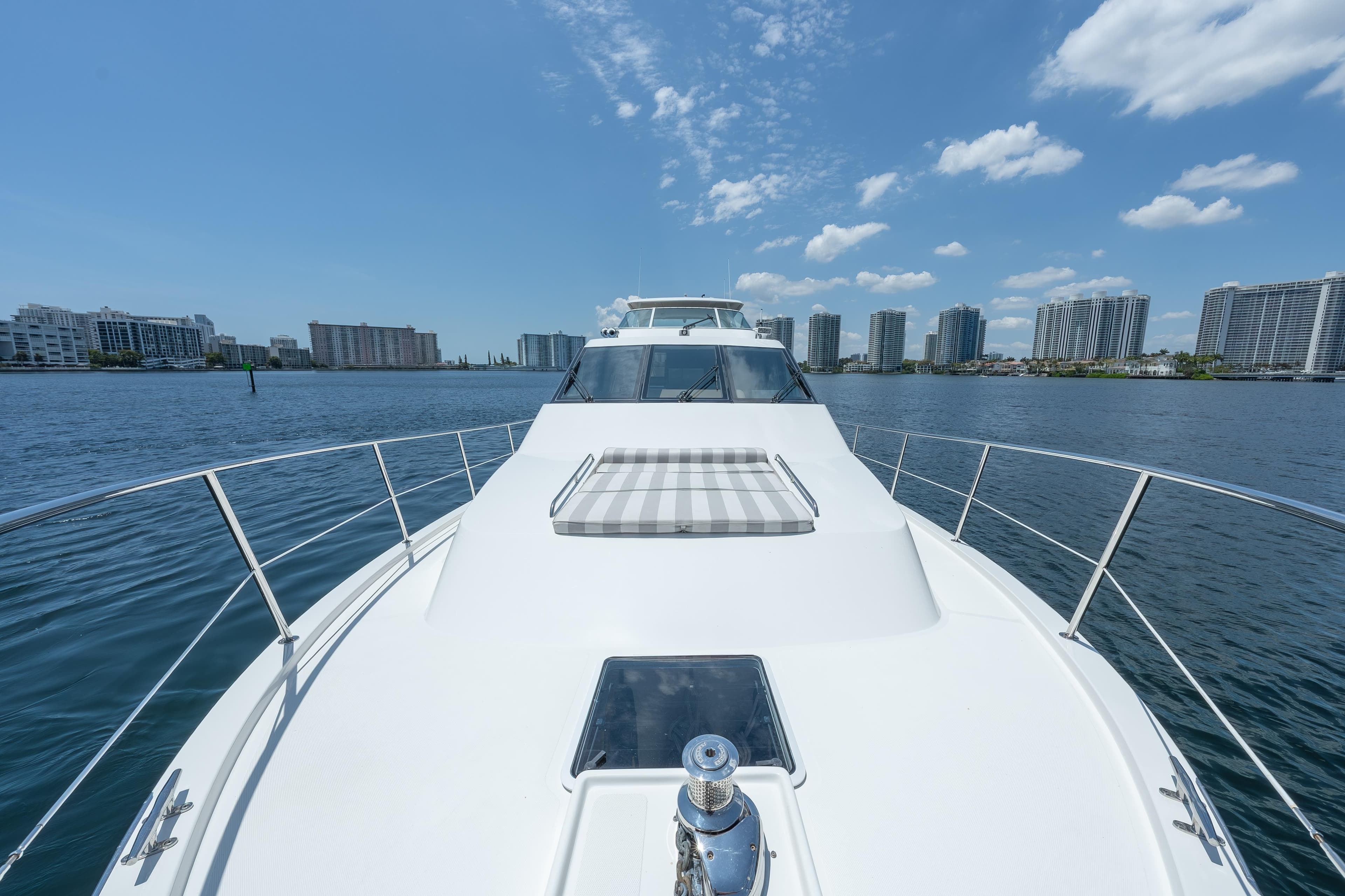 2007 Pacific Mariner Pilothouse yacht cruising near city skyline under blue sky.