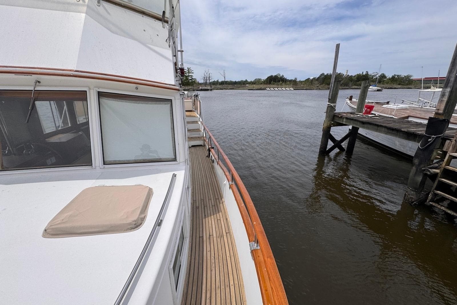 1989 Grand Banks 42 Motoryacht docked by a serene waterfront.