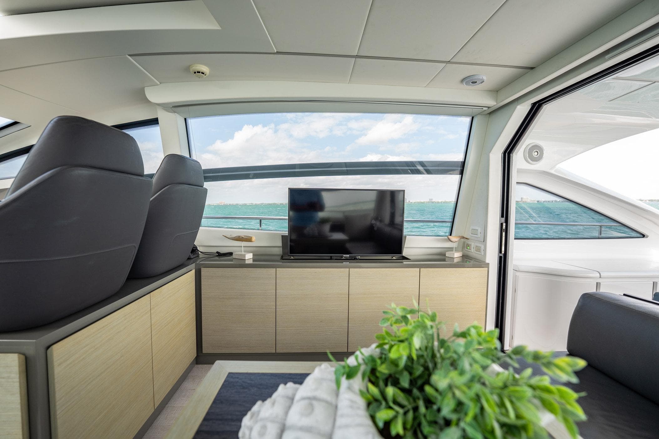 Interior of a 2020 Pershing 62 yacht with ocean view.