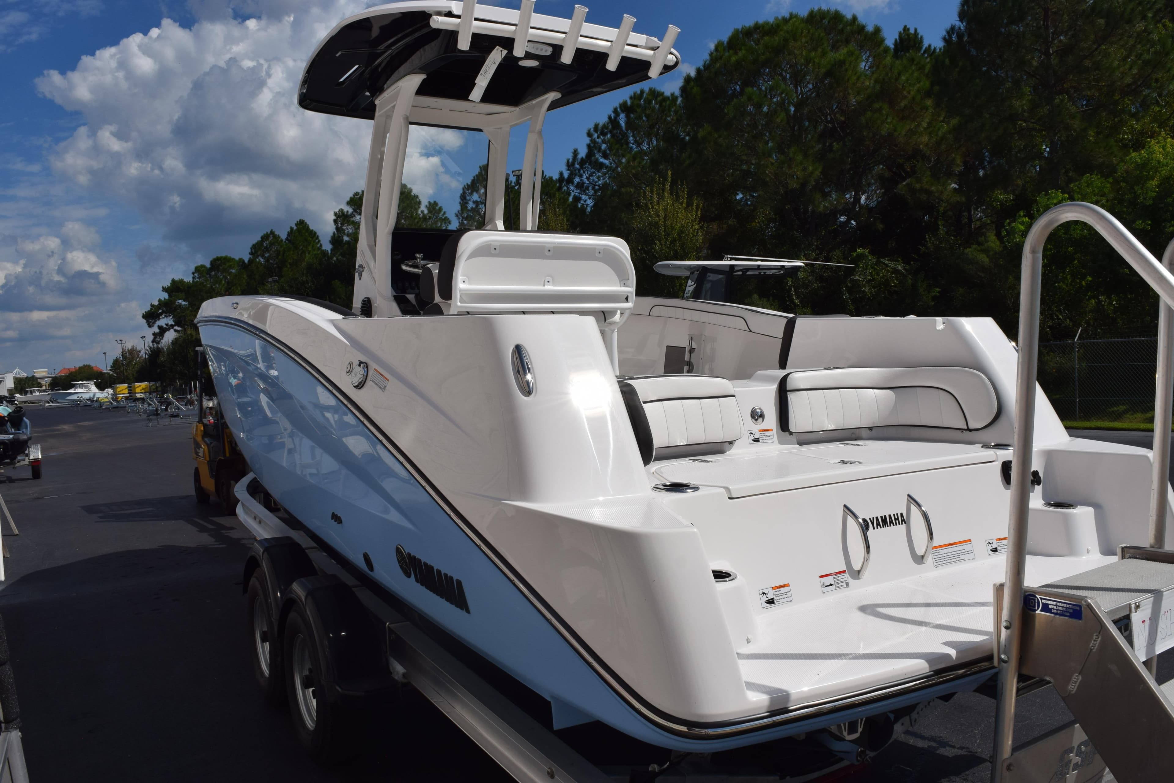 2026 Yamaha Boats 255 FSH Sport H, sleek white design, parked outdoors.
