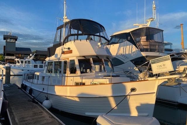 2000 Grand Banks 36 Classic yacht docked at marina during sunset.