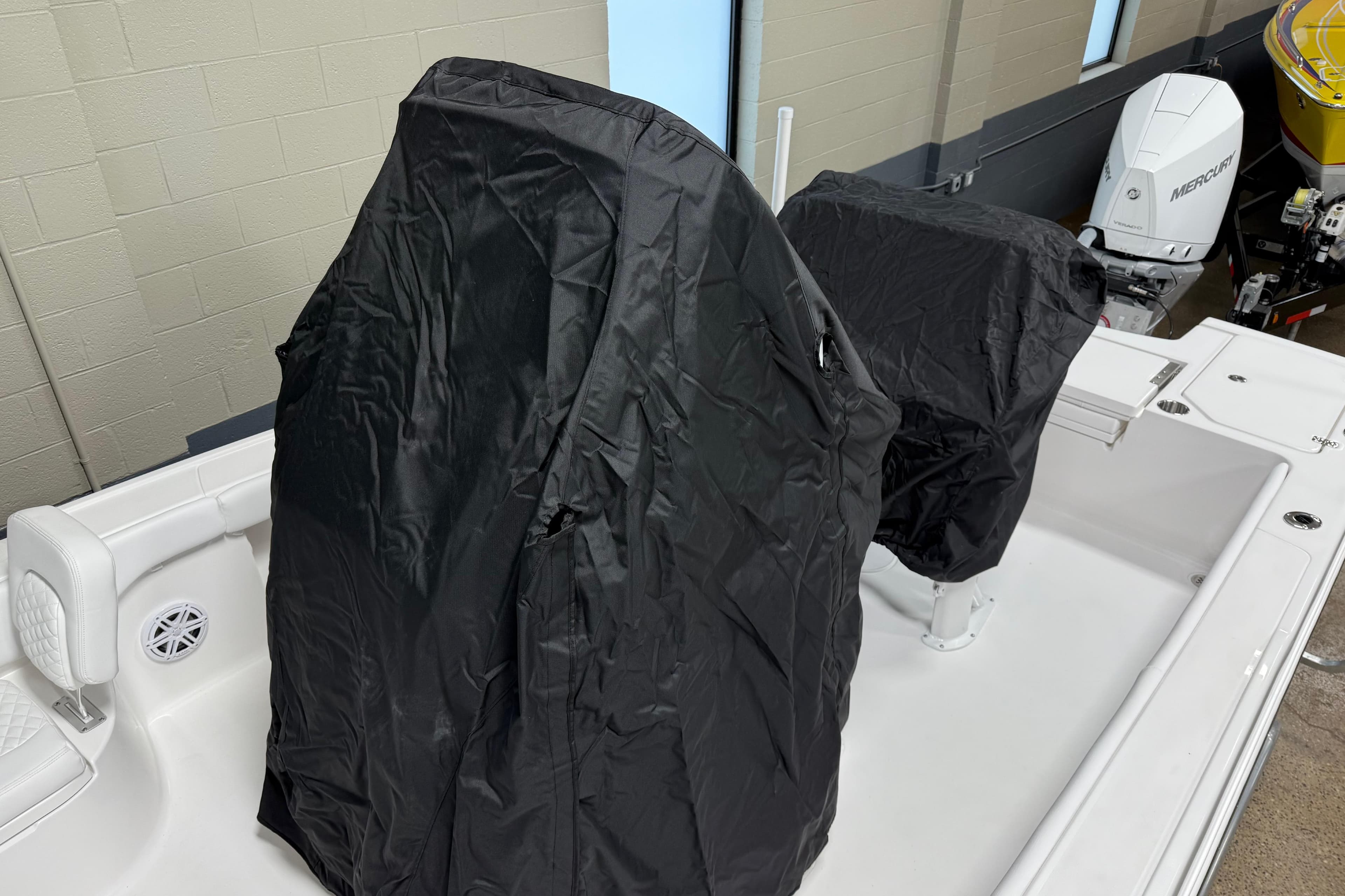 2026 Caymas 24 HB boat interior with black covers on seats and console.