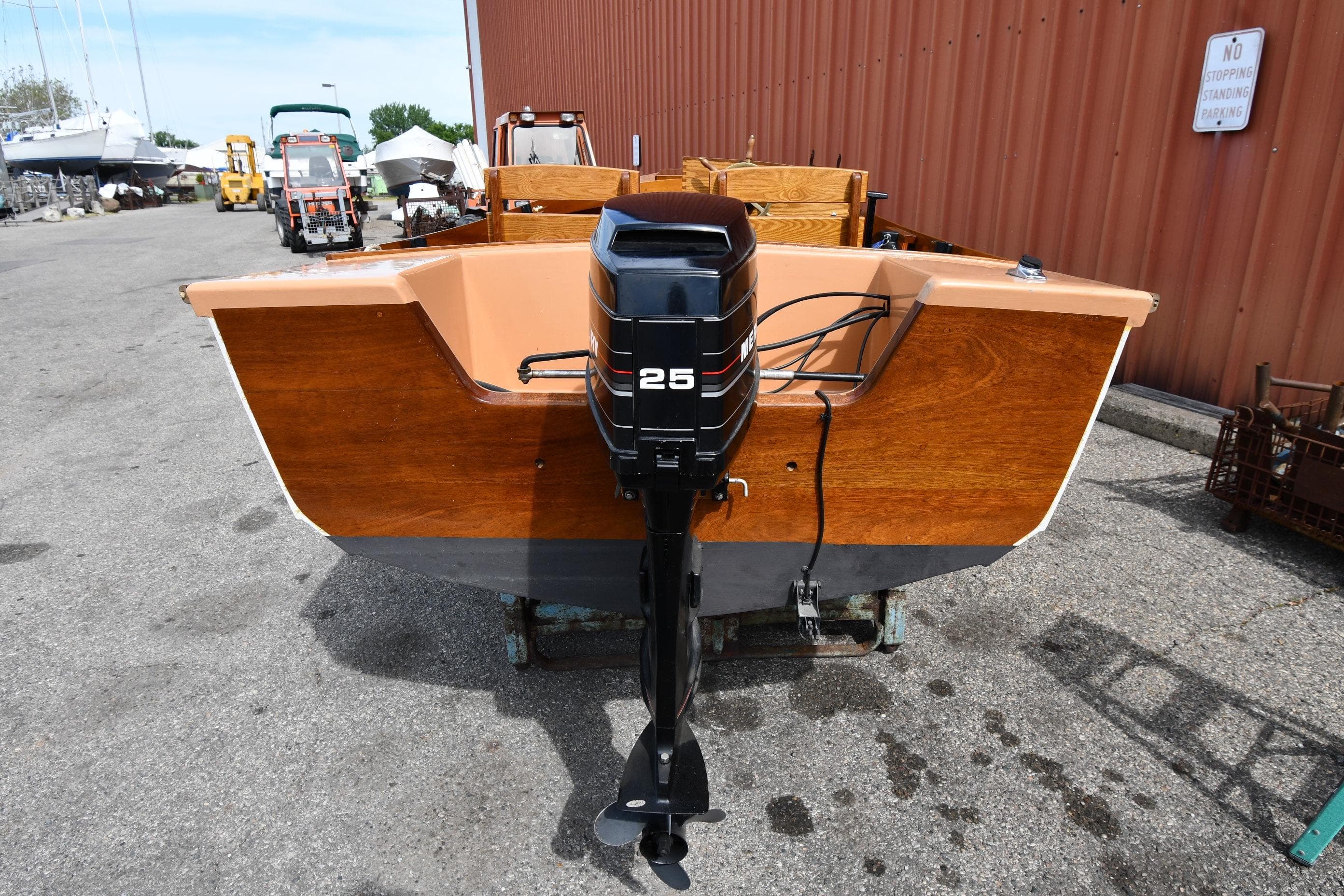 2003 Great Lakes 16 Skiff boat with 25 HP outboard motor, docked outdoors.