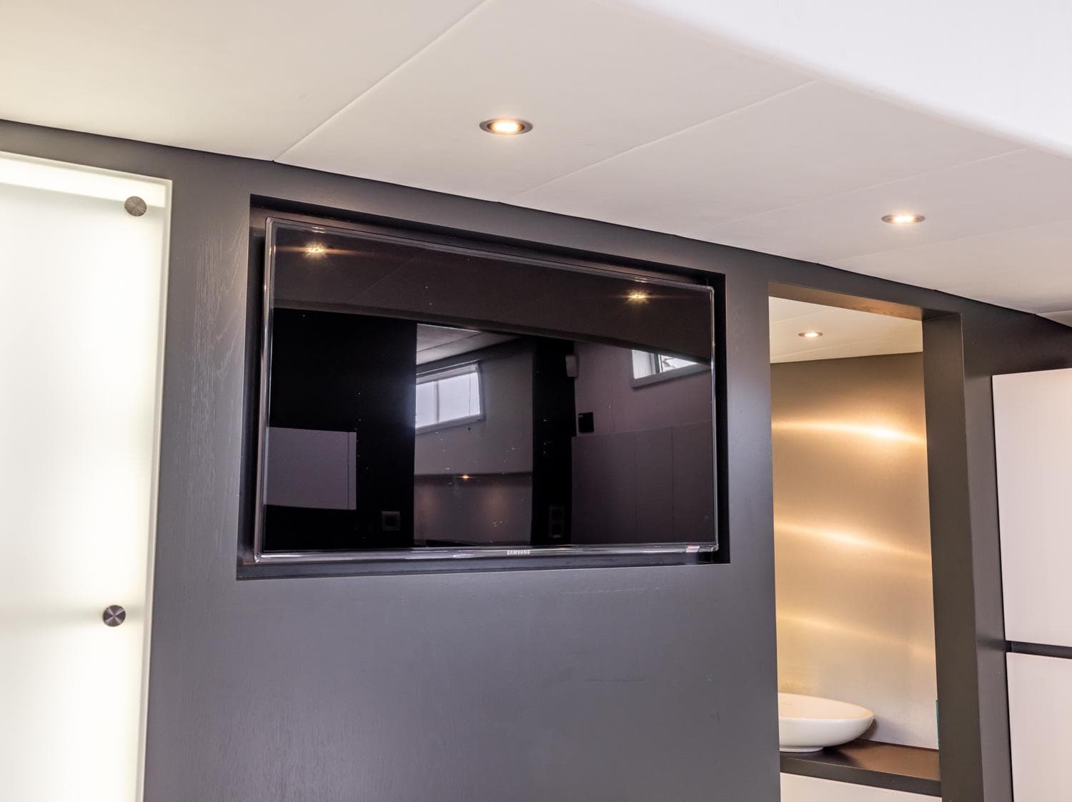 Modern interior of Bekebrede Luxemotor 19.95 yacht, featuring a sleek wall-mounted TV.