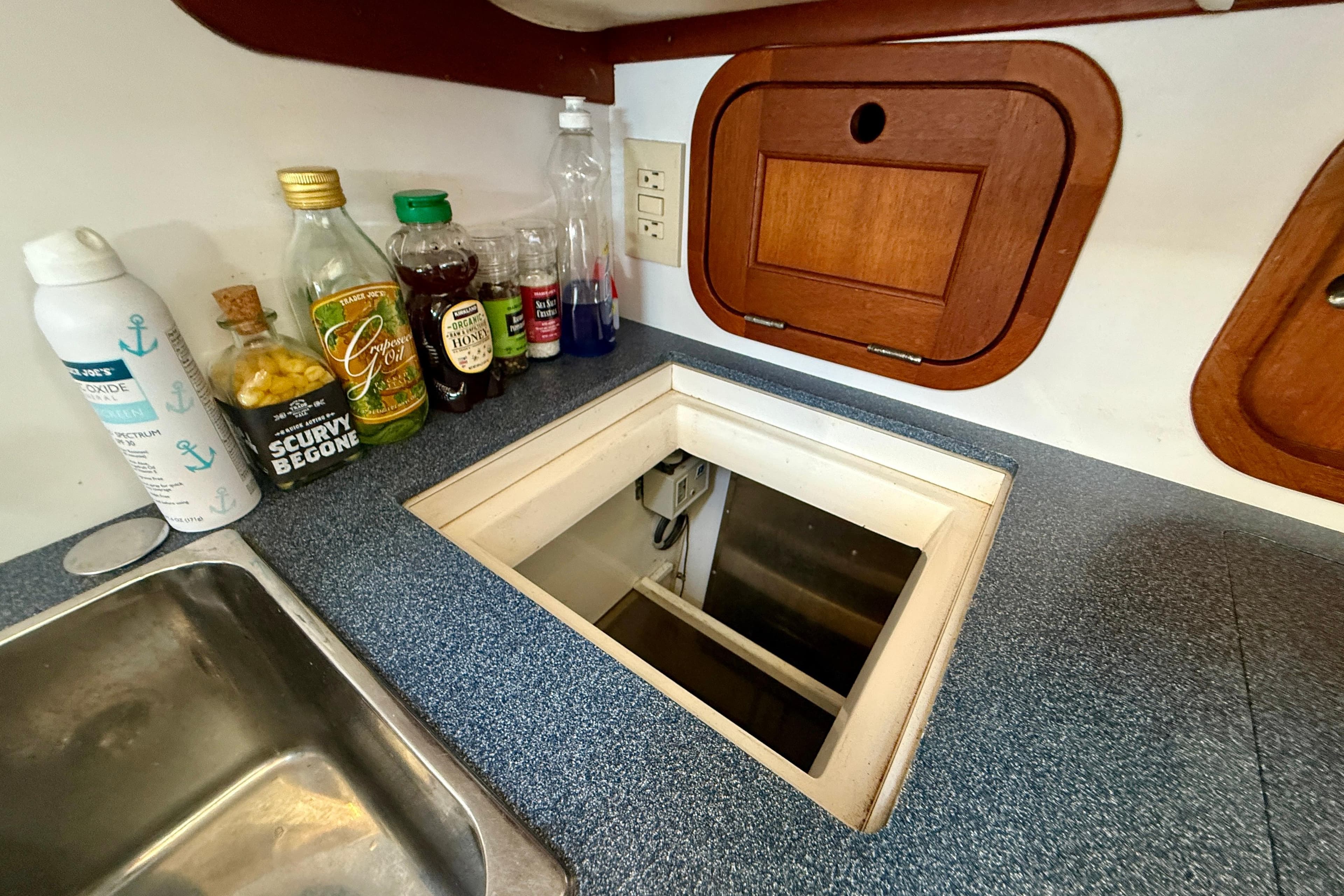 Kitchen area of a 1999 Legacy 40 boat with countertop and storage.