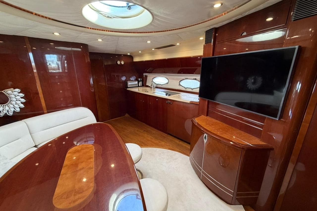 Luxurious interior of a 2003 Princess V58 yacht with elegant wood finishes and modern amenities.