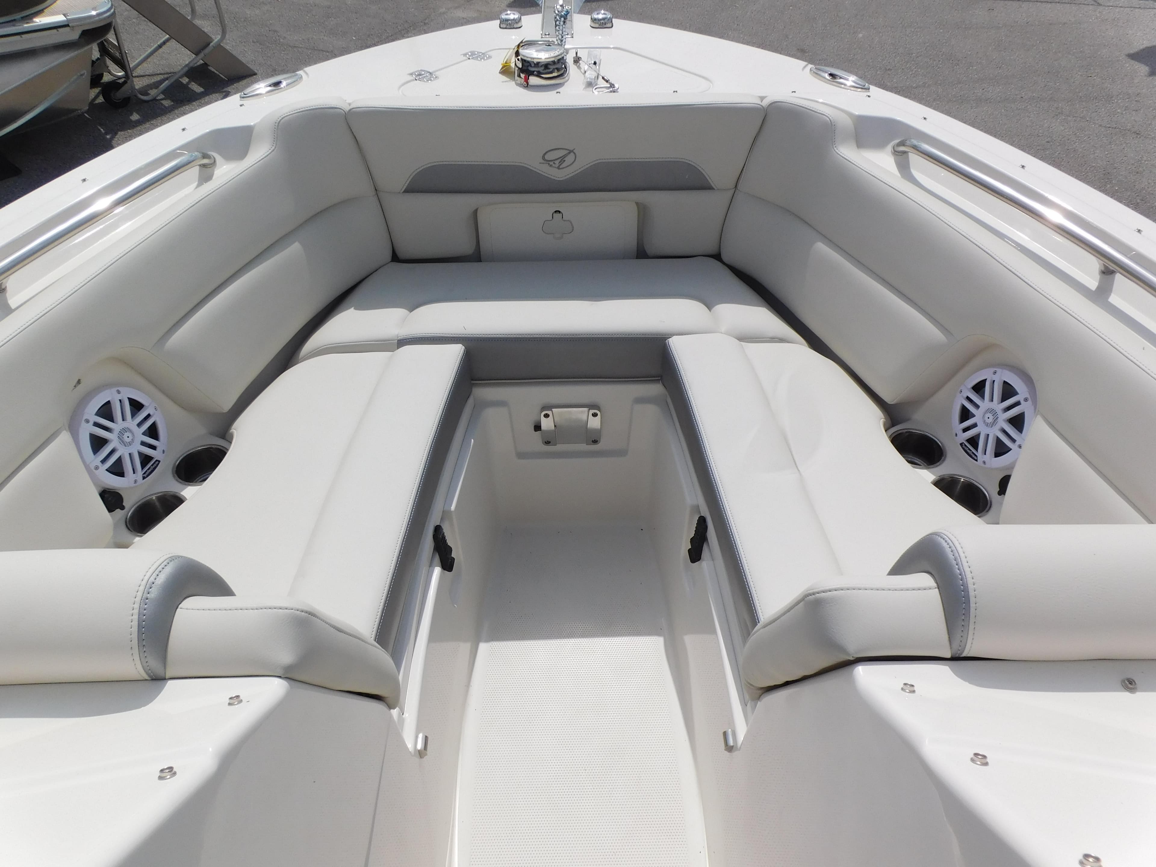 2025 Sailfish 245 DC boat interior with white seating and speakers.