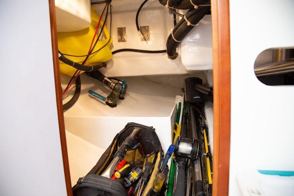 Storage compartment of 2015 Outbound 46 yacht with tools and equipment.