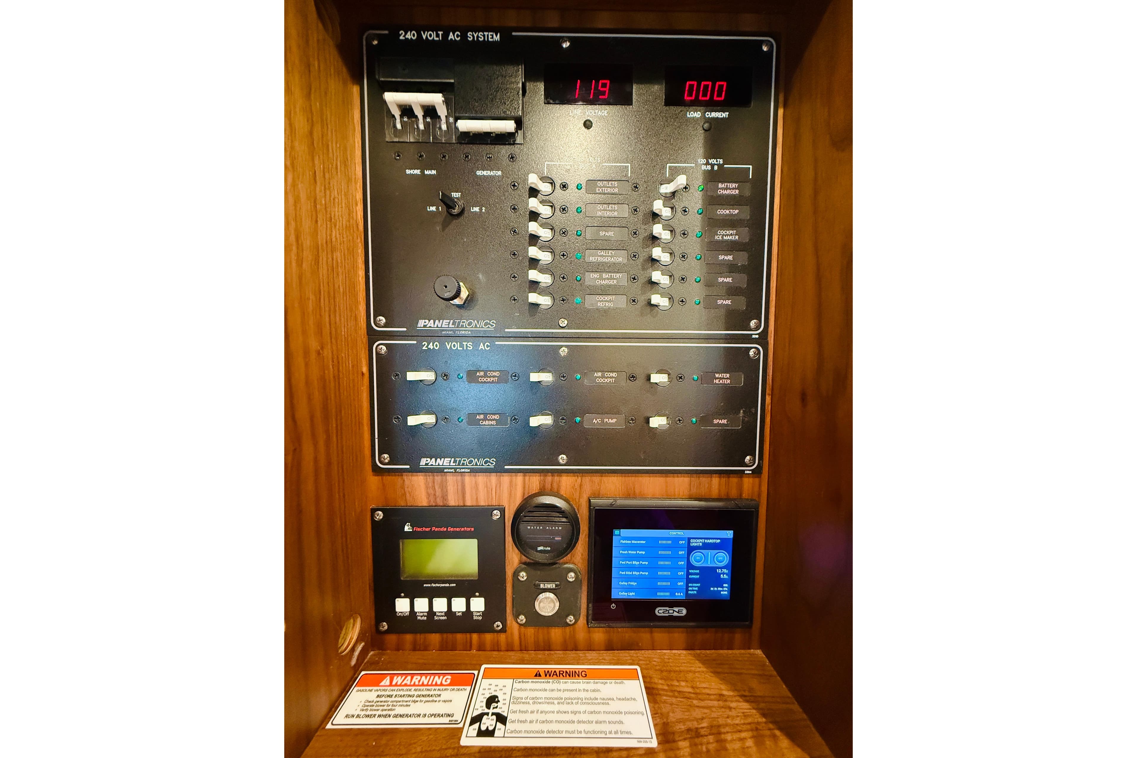 2021 Intrepid 410 Evolution electrical control panel with digital displays and warning labels.