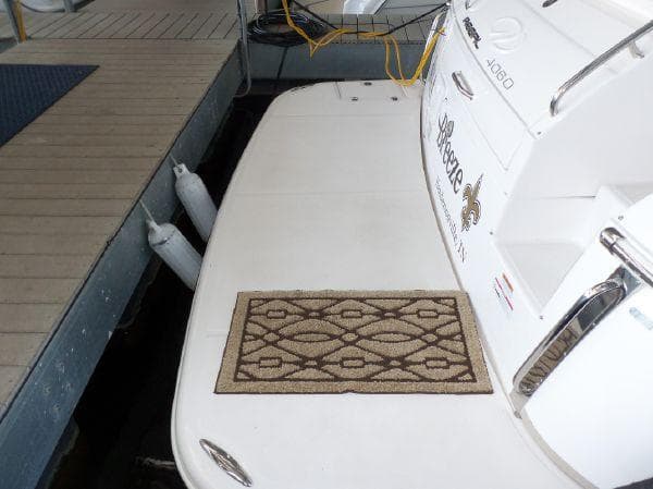 2009 Regal Commodore 4060 yacht docked with decorative mat on deck.