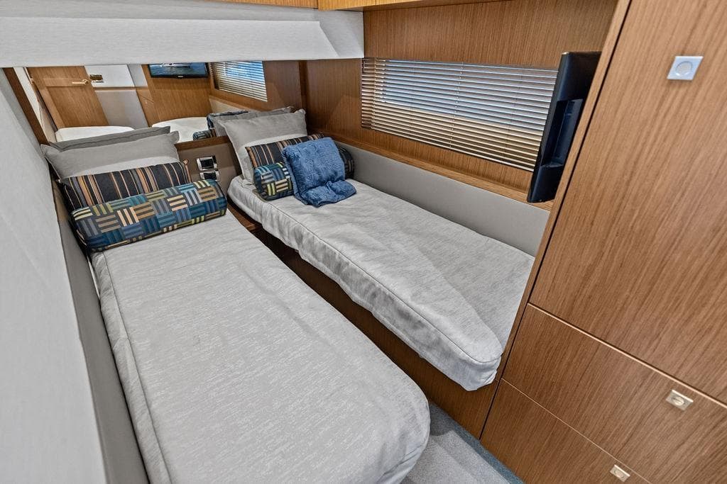 Luxurious twin cabin interior of 2017 Sea Ray Fly 510 yacht with modern decor.