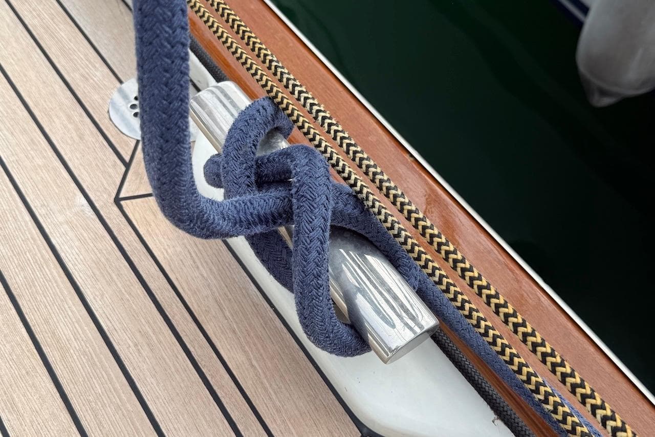 Blue rope tied on a cleat aboard a 2002 Moody 47 yacht.