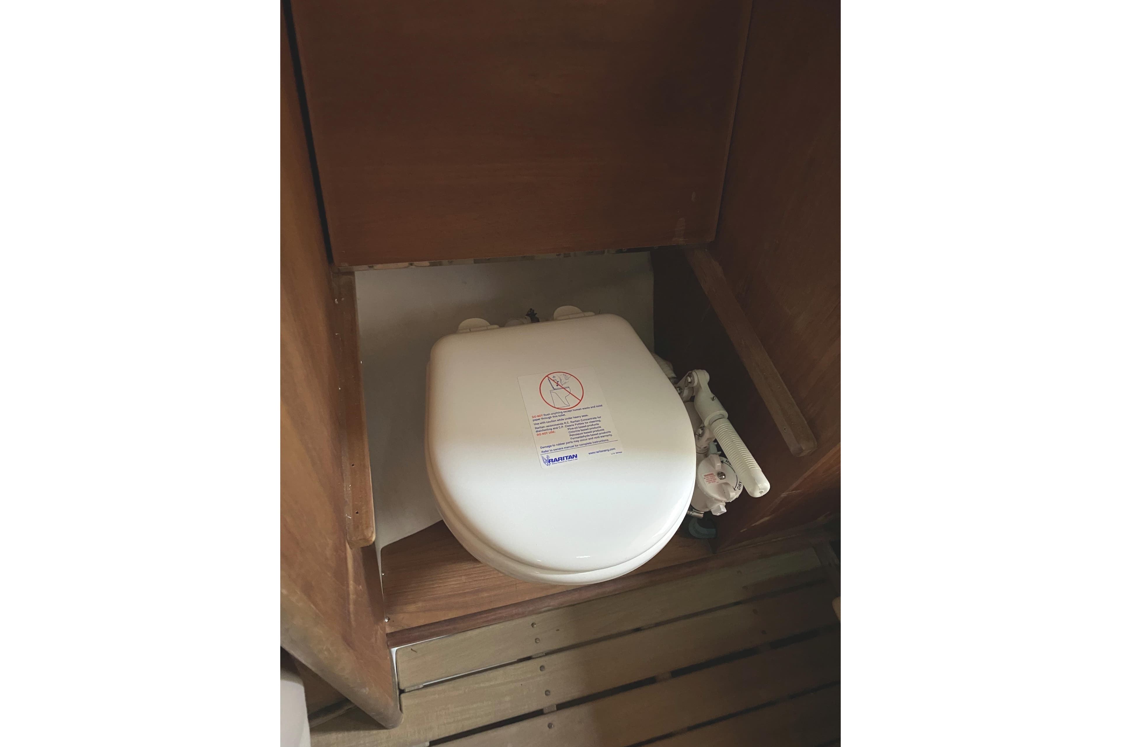 1997 Wasque C.W.Hood Wasque 26 boat toilet in wooden compartment.