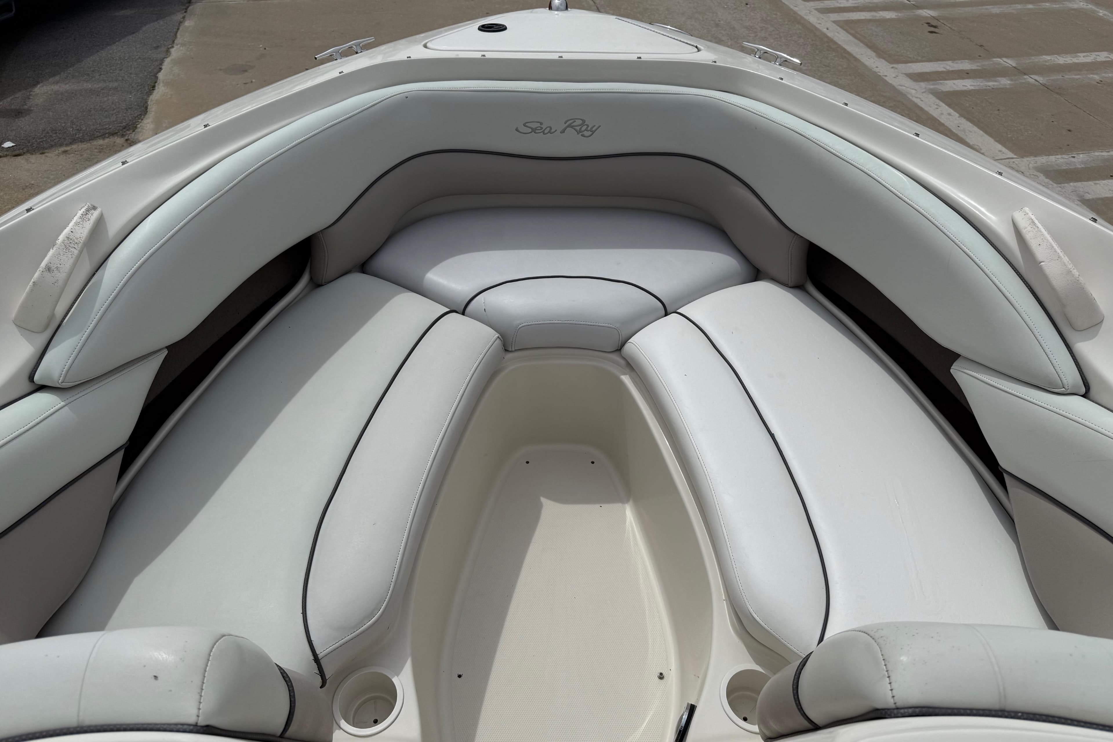 2003 Sea Ray 240 Bow Rider boat interior with white cushioned seating.