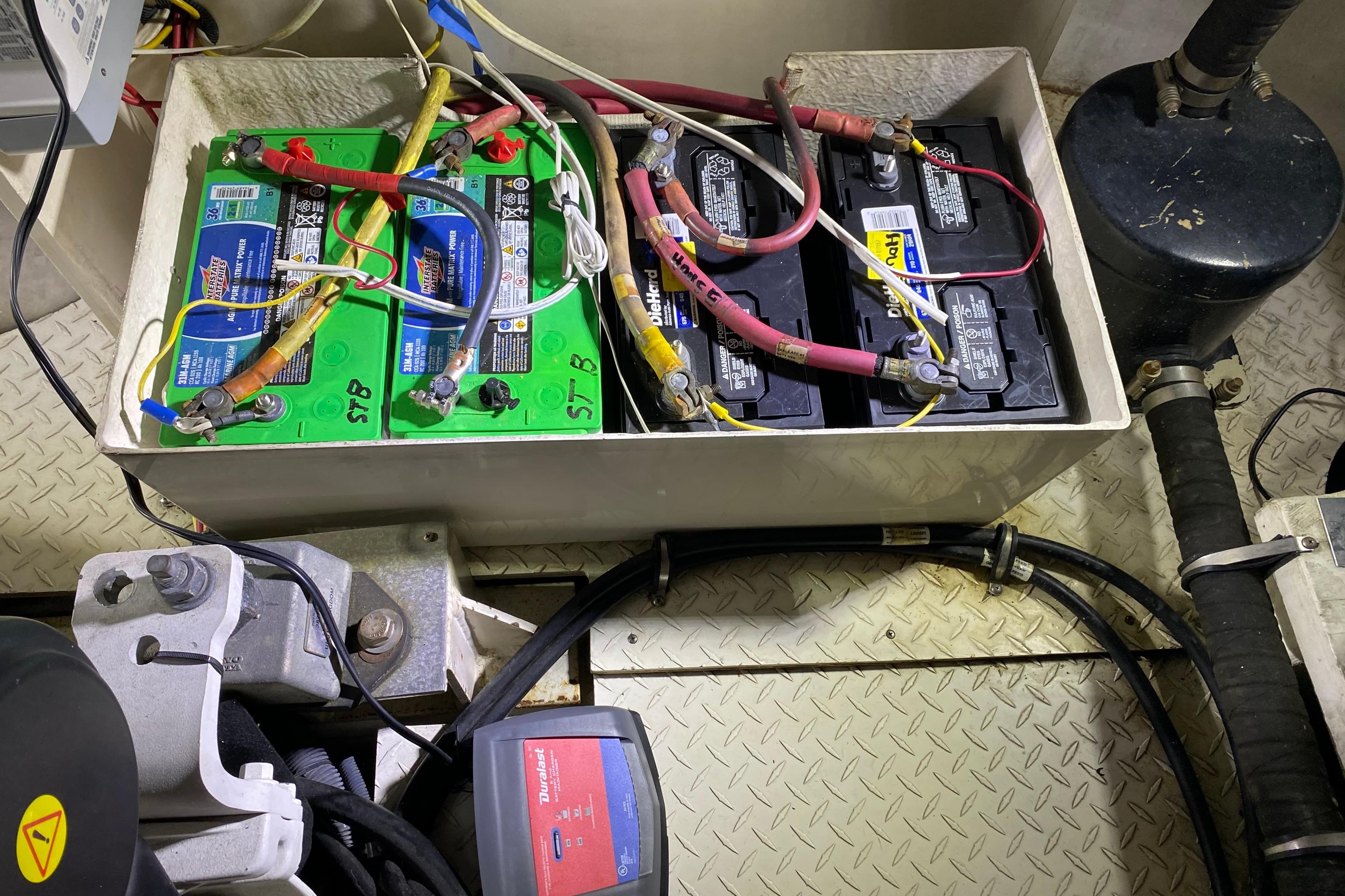 Battery compartment of a 2006 Cruisers Yachts 520 Express, showing wiring and connections.