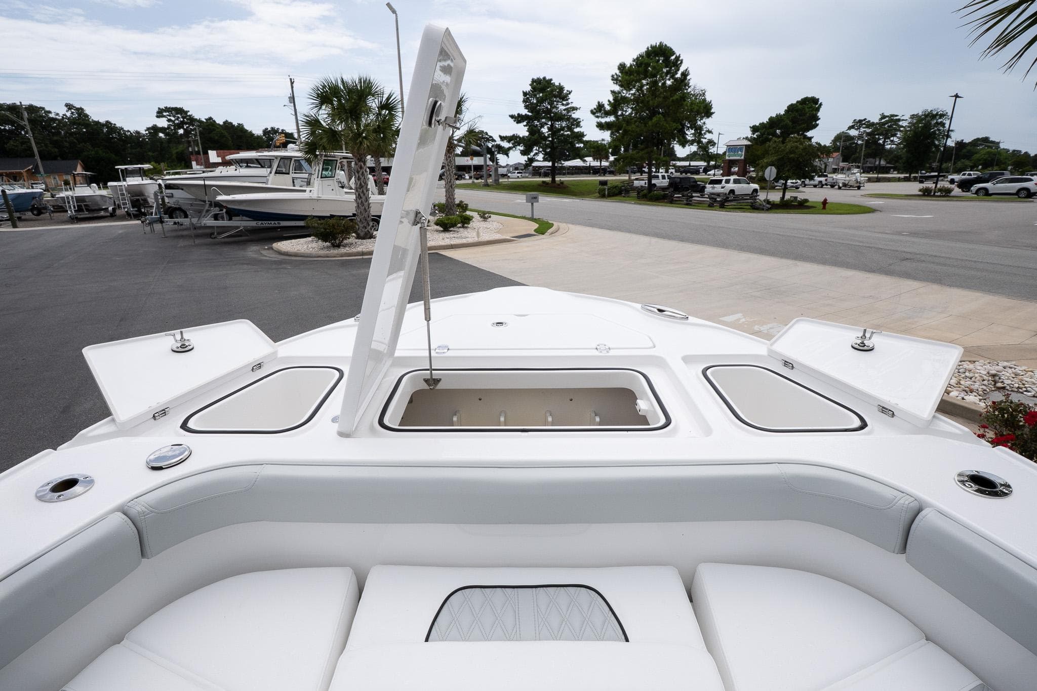 2026 Blackfin 262 HB boat with open storage compartment, docked in a marina.