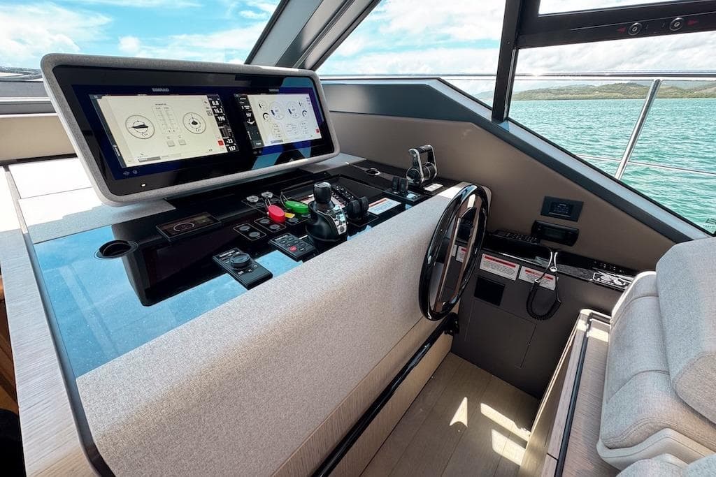 2024 Ferretti Yachts 580 helm with advanced navigation system and ocean view.