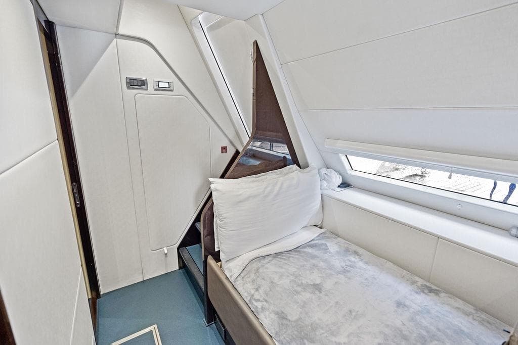 2019 Sunseeker 76 Yacht interior cabin with modern design and comfortable bedding.