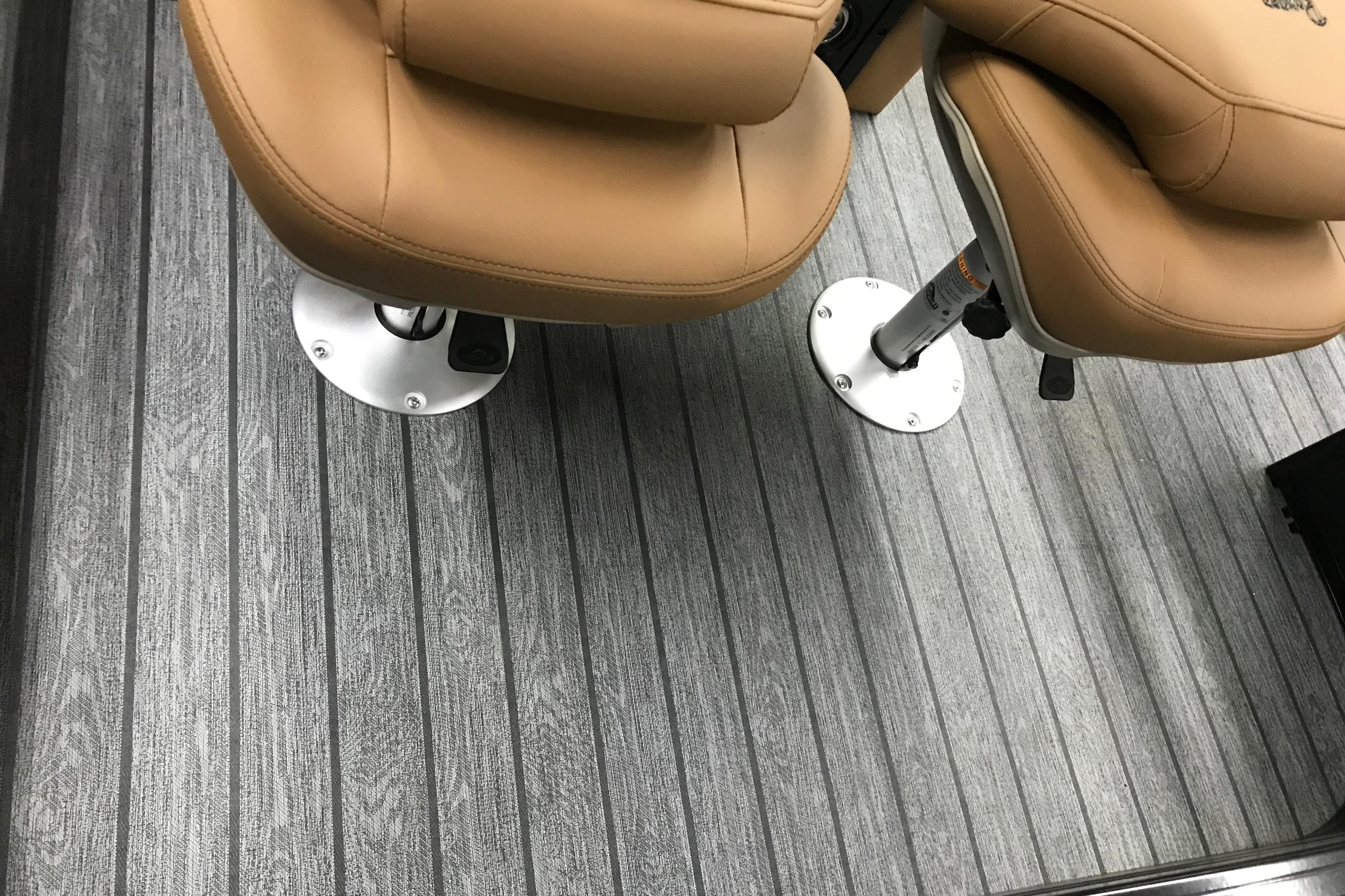 2026 Ranger Reata 220FC boat seats on sleek, striped flooring.