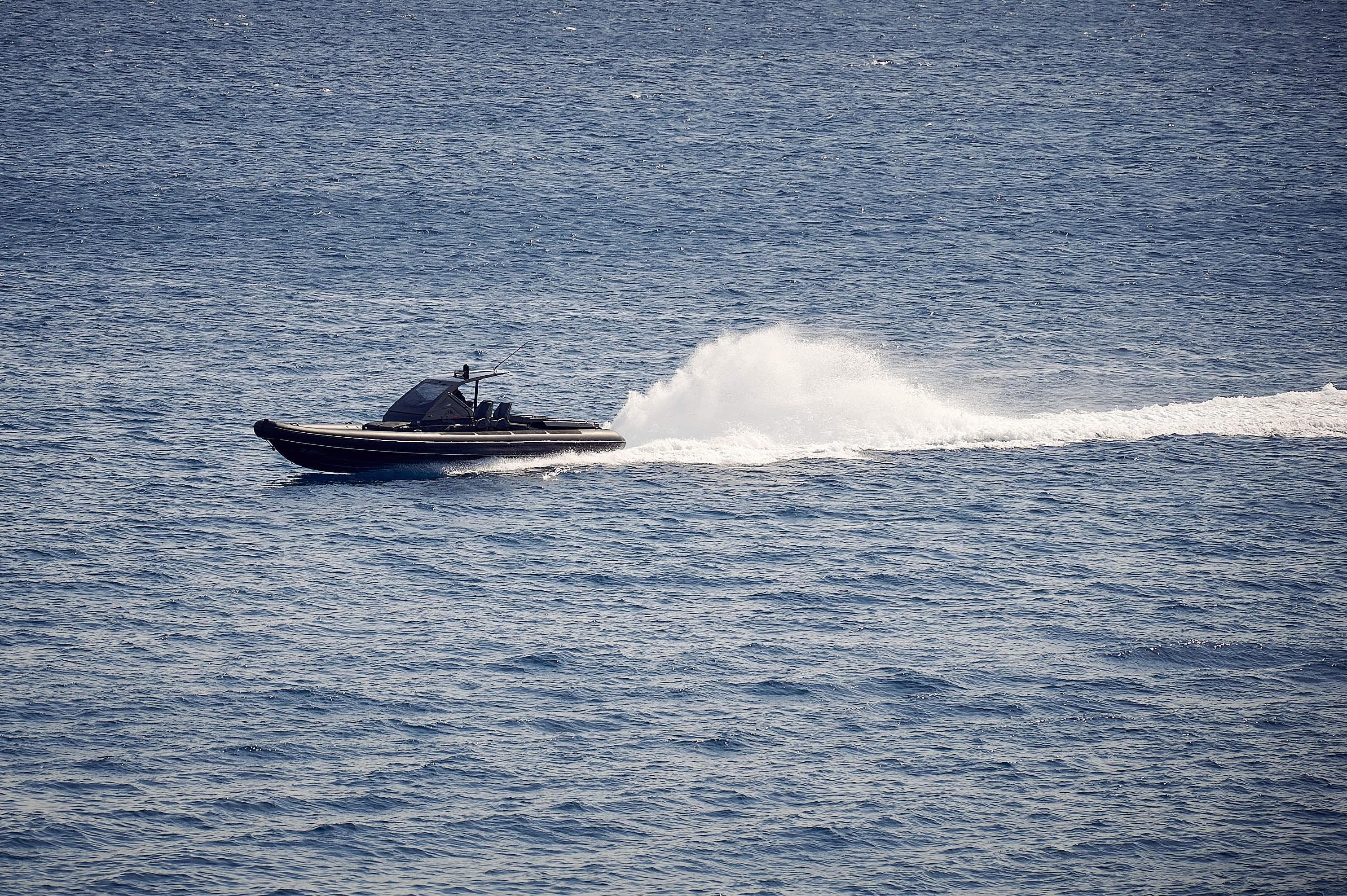 2016 Goldfish 38 Supersport speeding on open water, creating a trail of white spray.