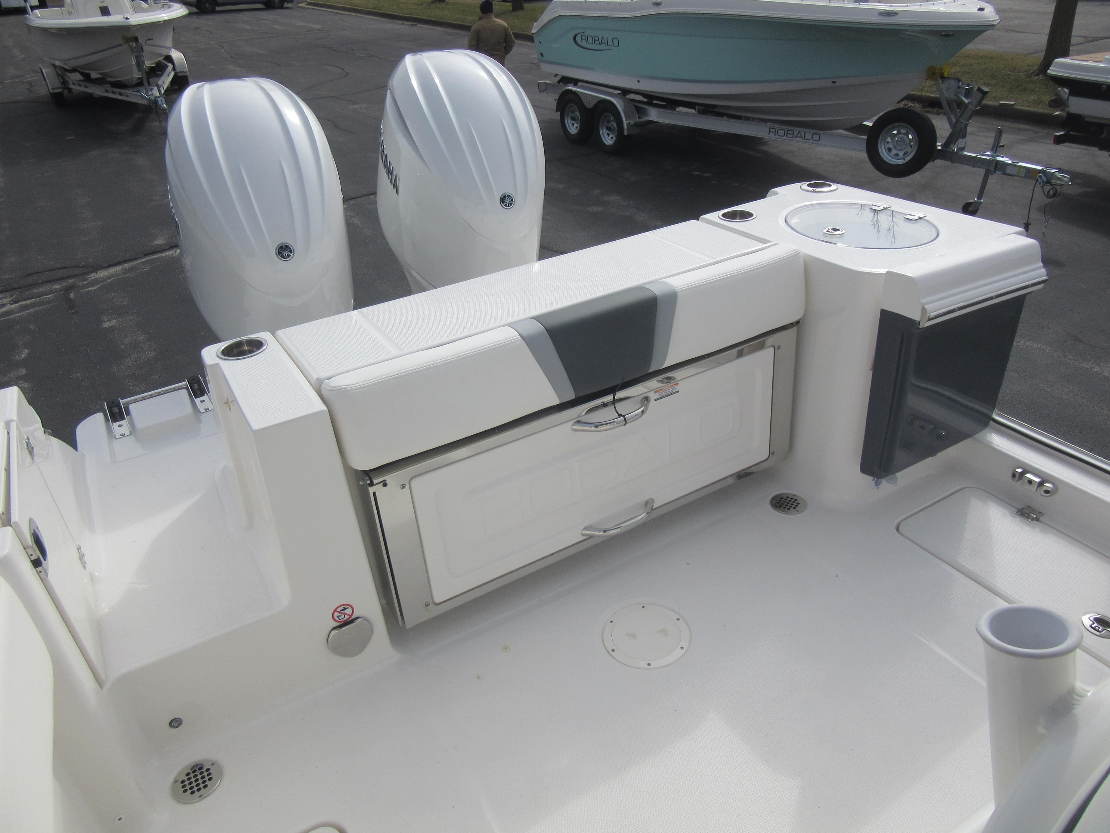 2024 Robalo R250 Center Console boat with twin engines and rear seating.