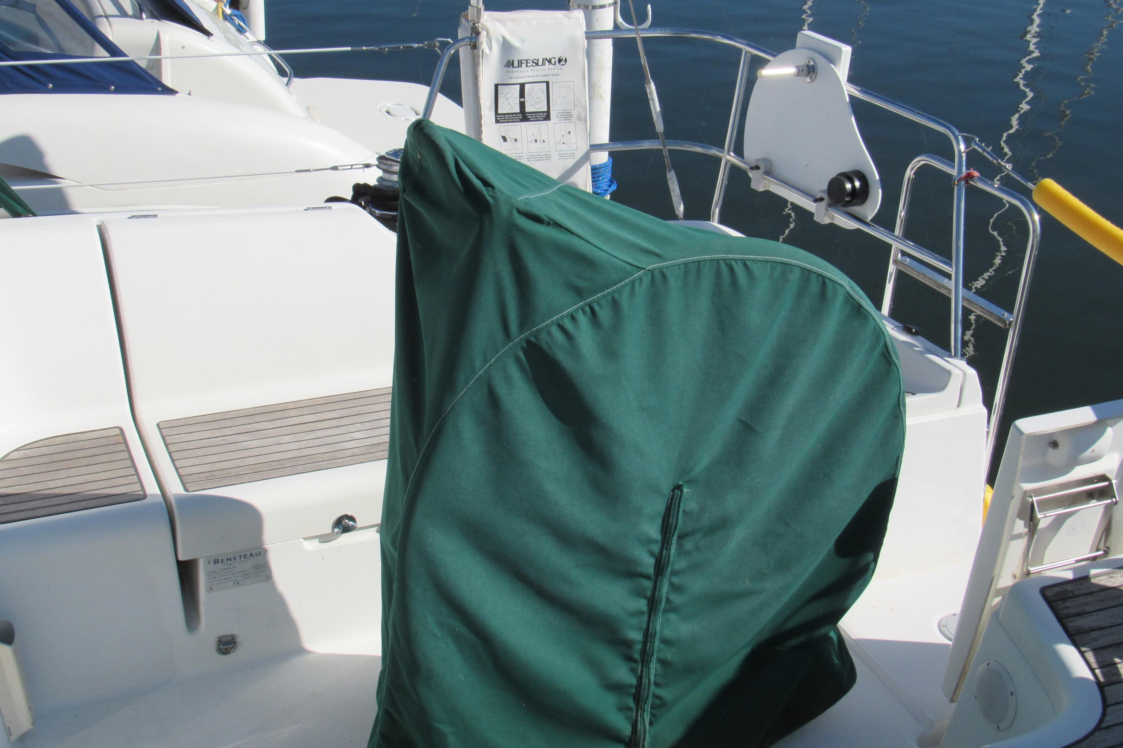 2005 Beneteau Oceanis 373 sailboat cockpit with green cover and seating area.