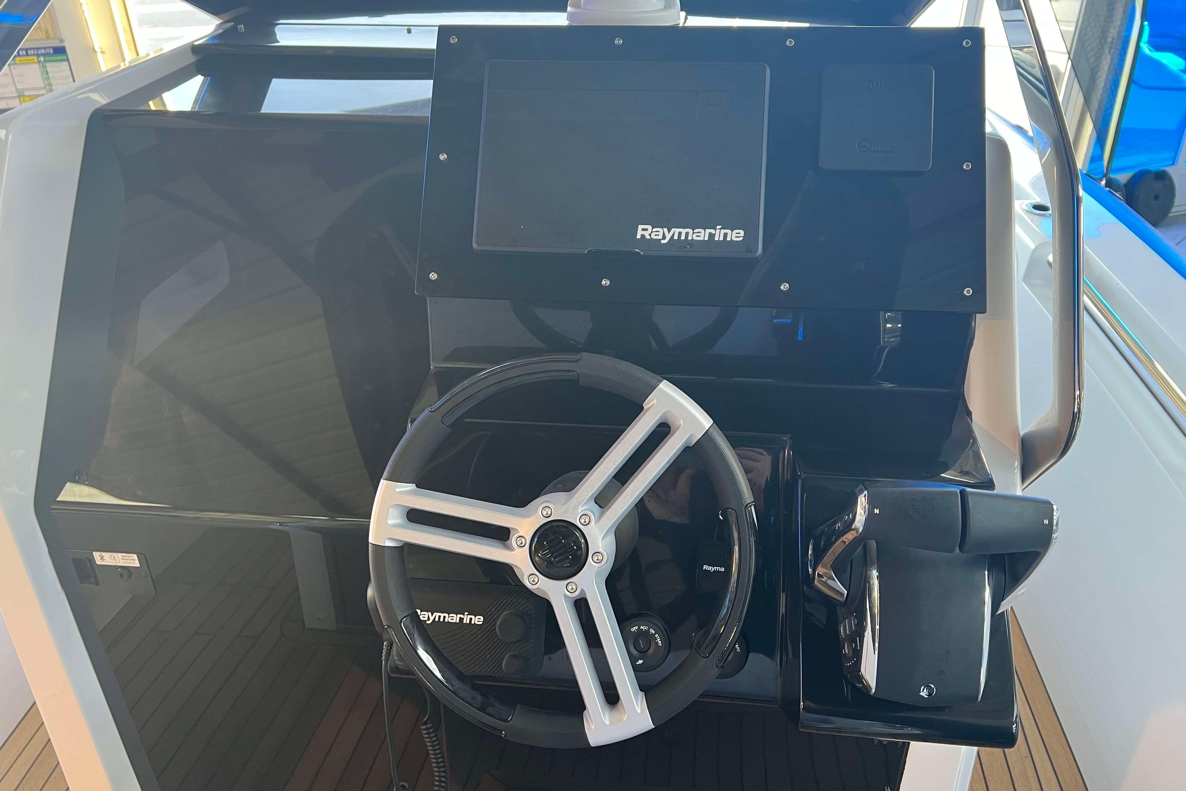 2024 Pirelli 30 boat dashboard with Raymarine navigation system and steering wheel.