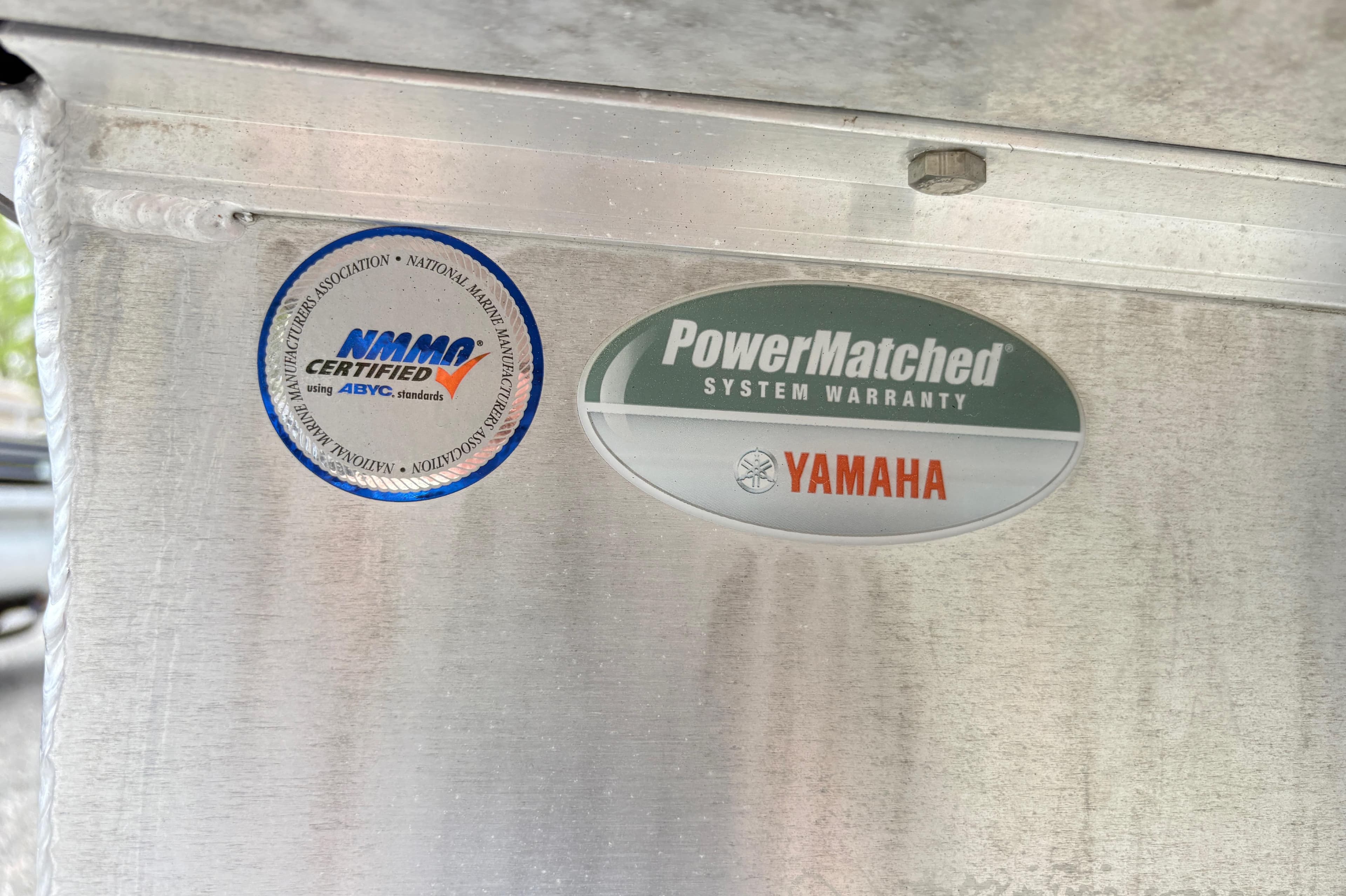 Stickers on SunCatcher X322 RC, 2023 model, showing NMMA certification and Yamaha warranty.