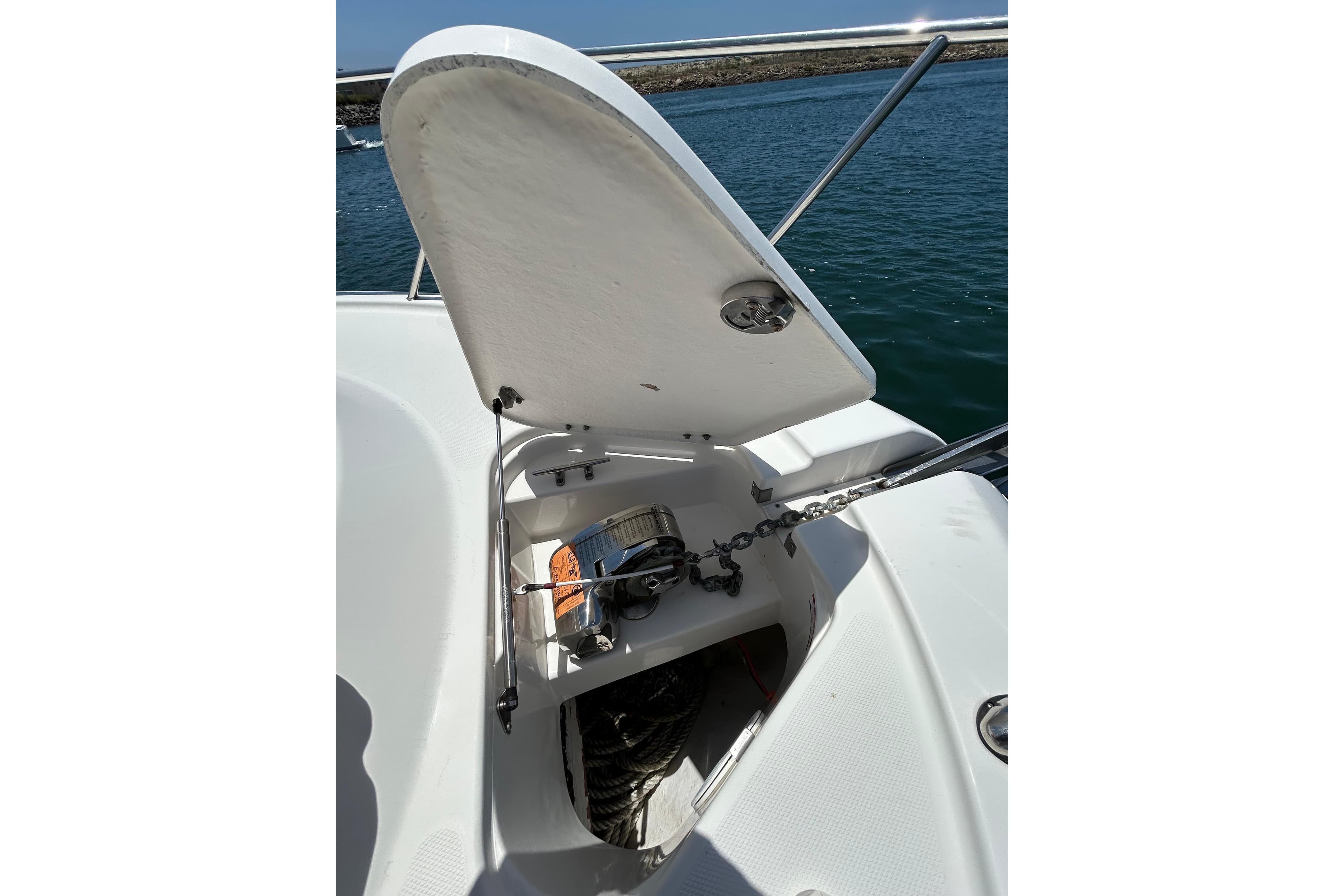 2007 Robalo R305 Walkaround anchor locker with open hatch and visible chain mechanism.