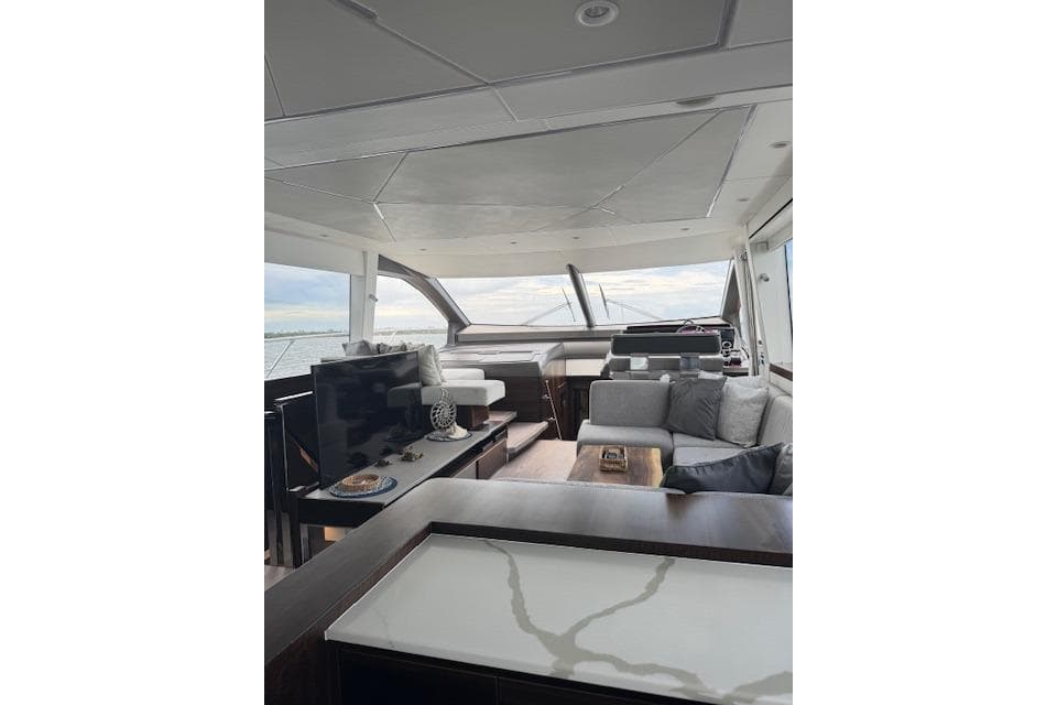 Luxurious interior of 2022 Sunseeker Manhattan 68 yacht with modern furnishings and panoramic windows.