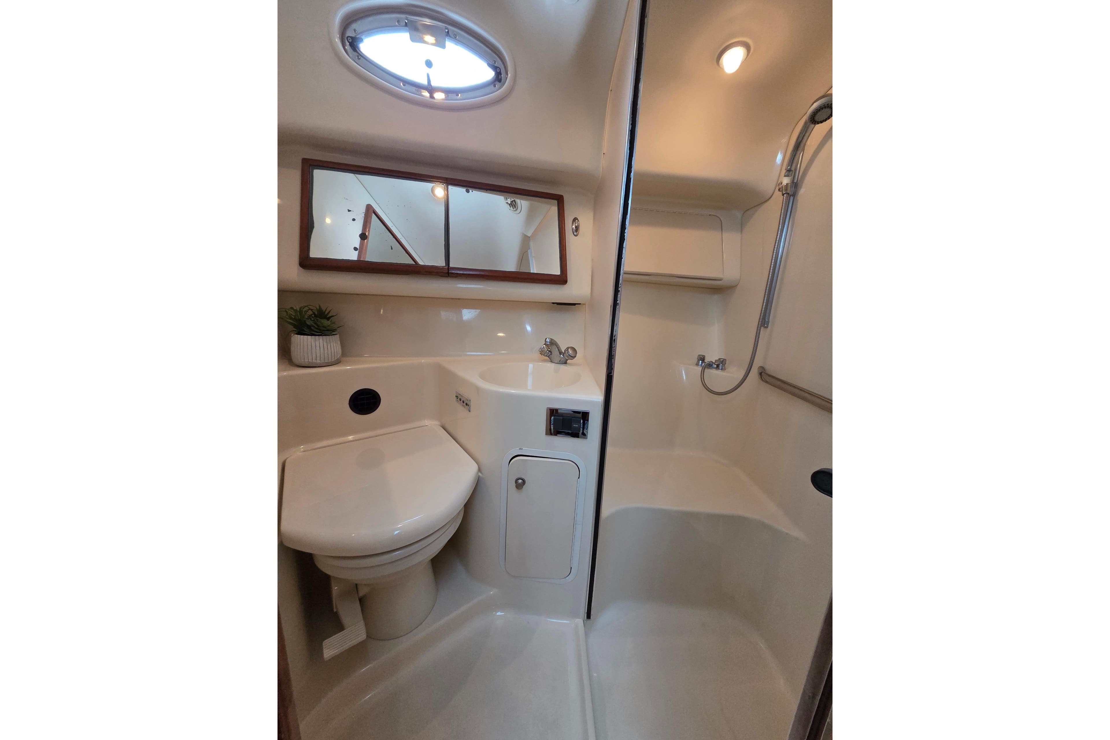 Bathroom interior of 2000 Sea Ray 420 Aft Cabin yacht, featuring shower and toilet.