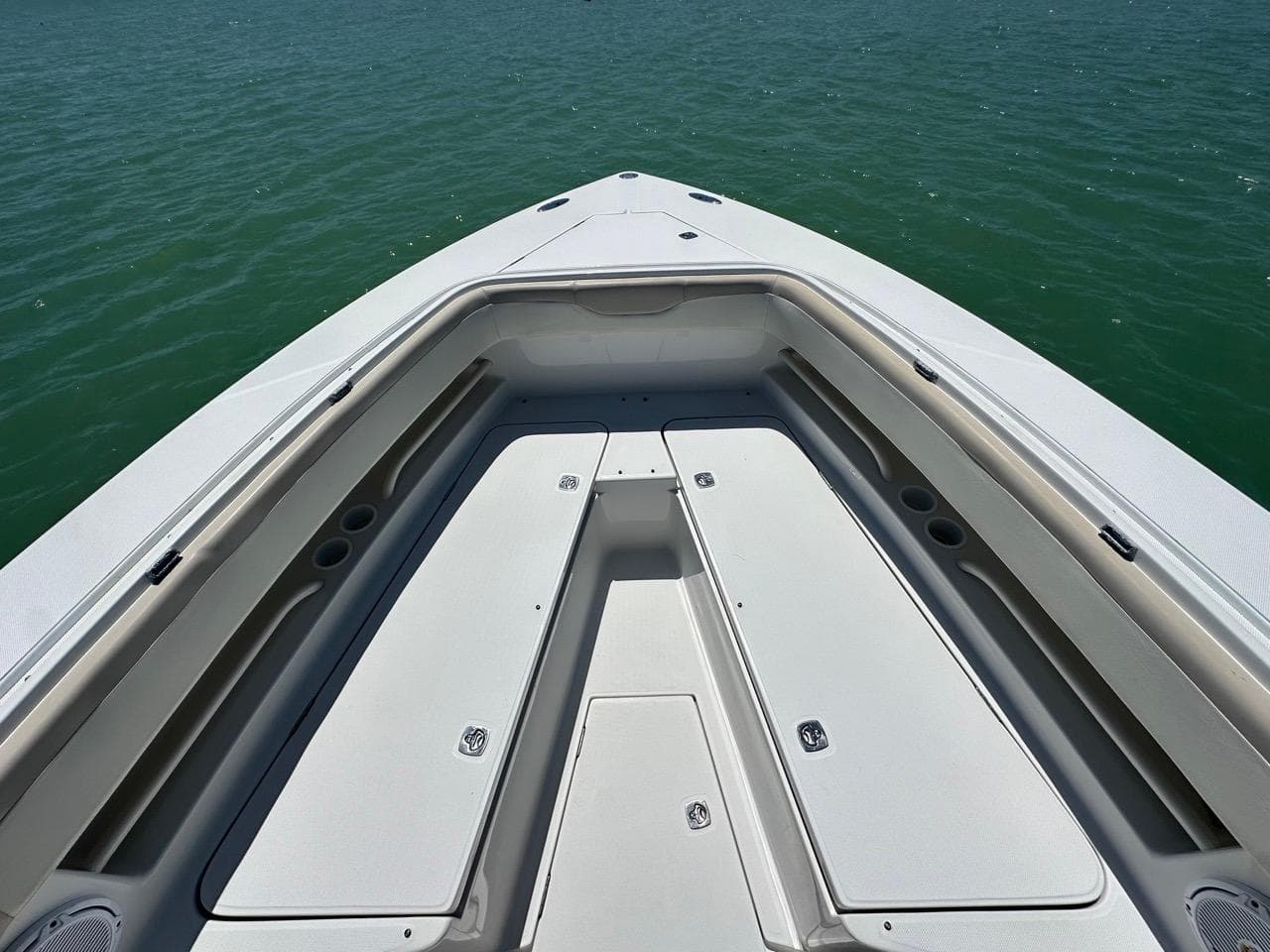 2009 Jupiter 29 FS CC boat deck with storage compartments on calm water.