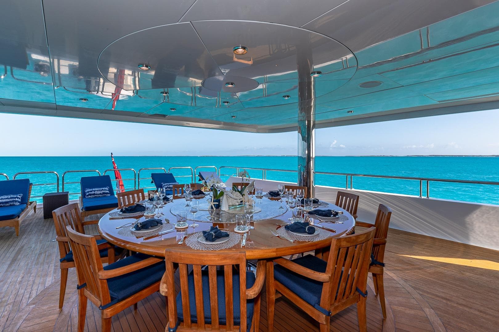 Luxurious dining area on 2005 Christensen motor yacht with ocean view.