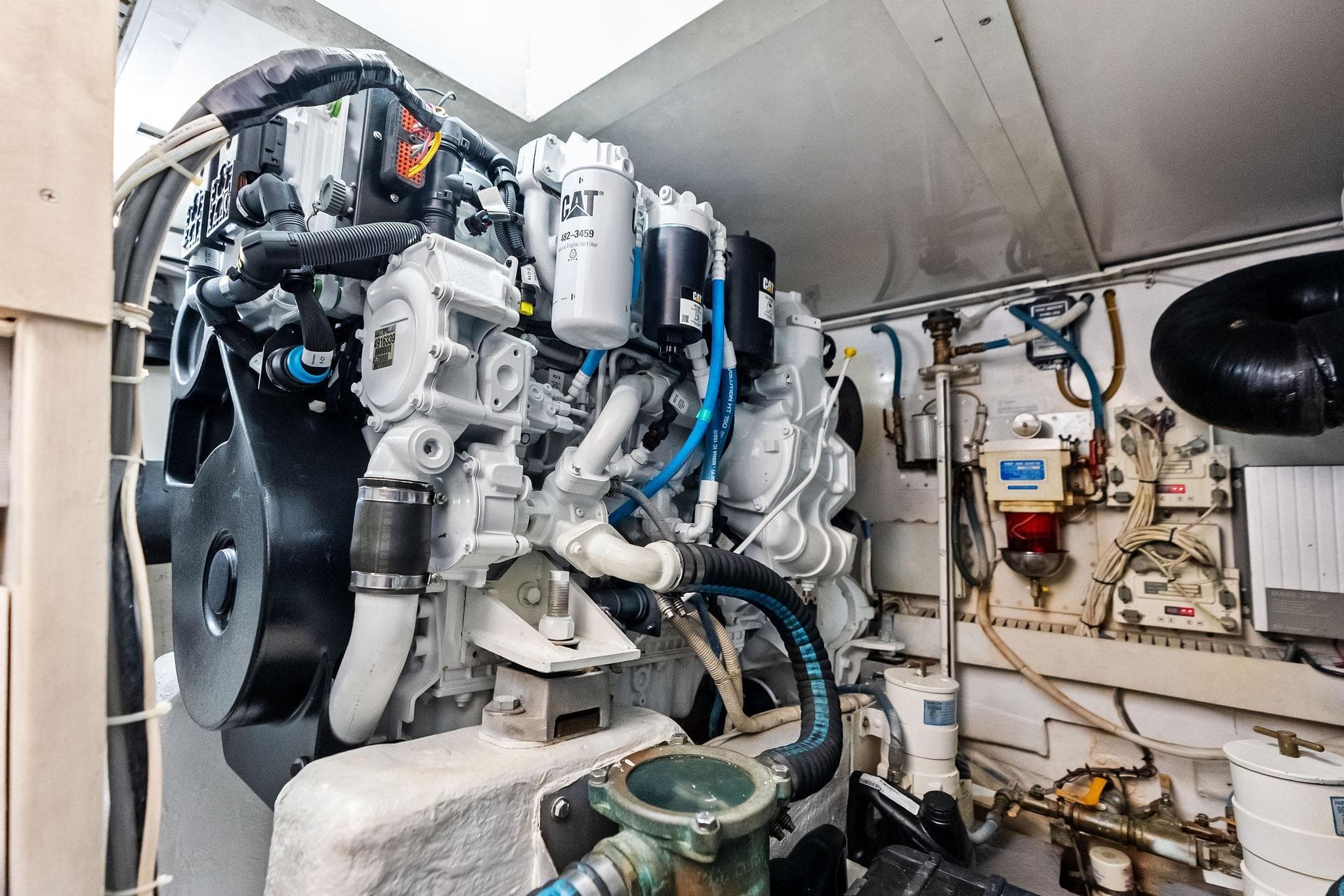 Engine room of a 2006 Bertram 39 Convertible yacht, showcasing detailed machinery.