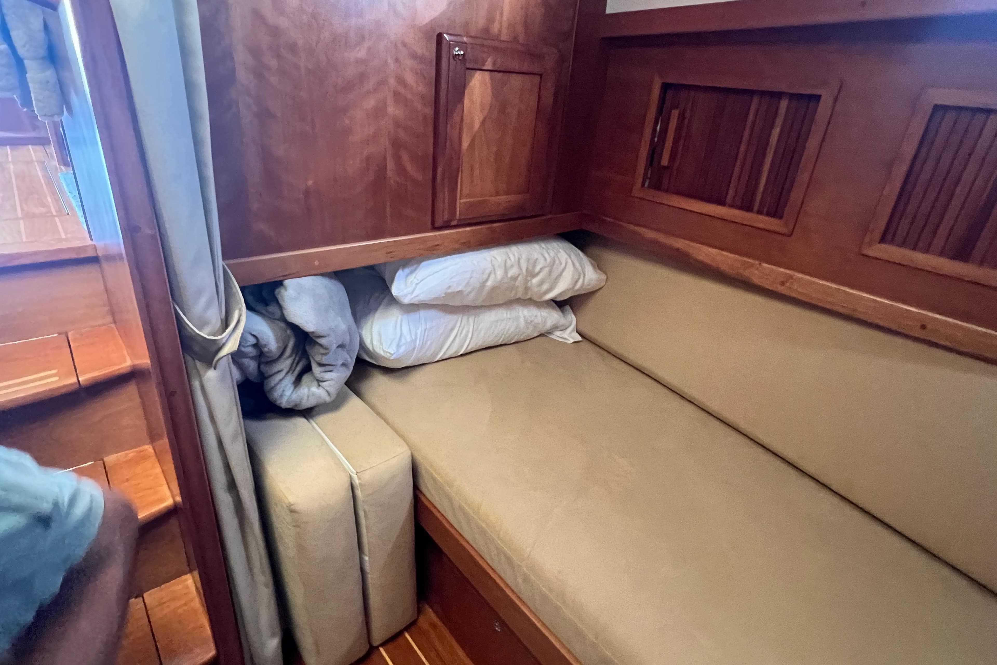 2005 Sabre Flybridge interior with cozy wooden cabin and cushioned seating area.