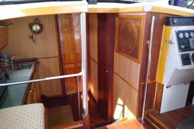 Interior of 1979 Mainship 34 Custom Sedan with wood paneling and nautical decor.