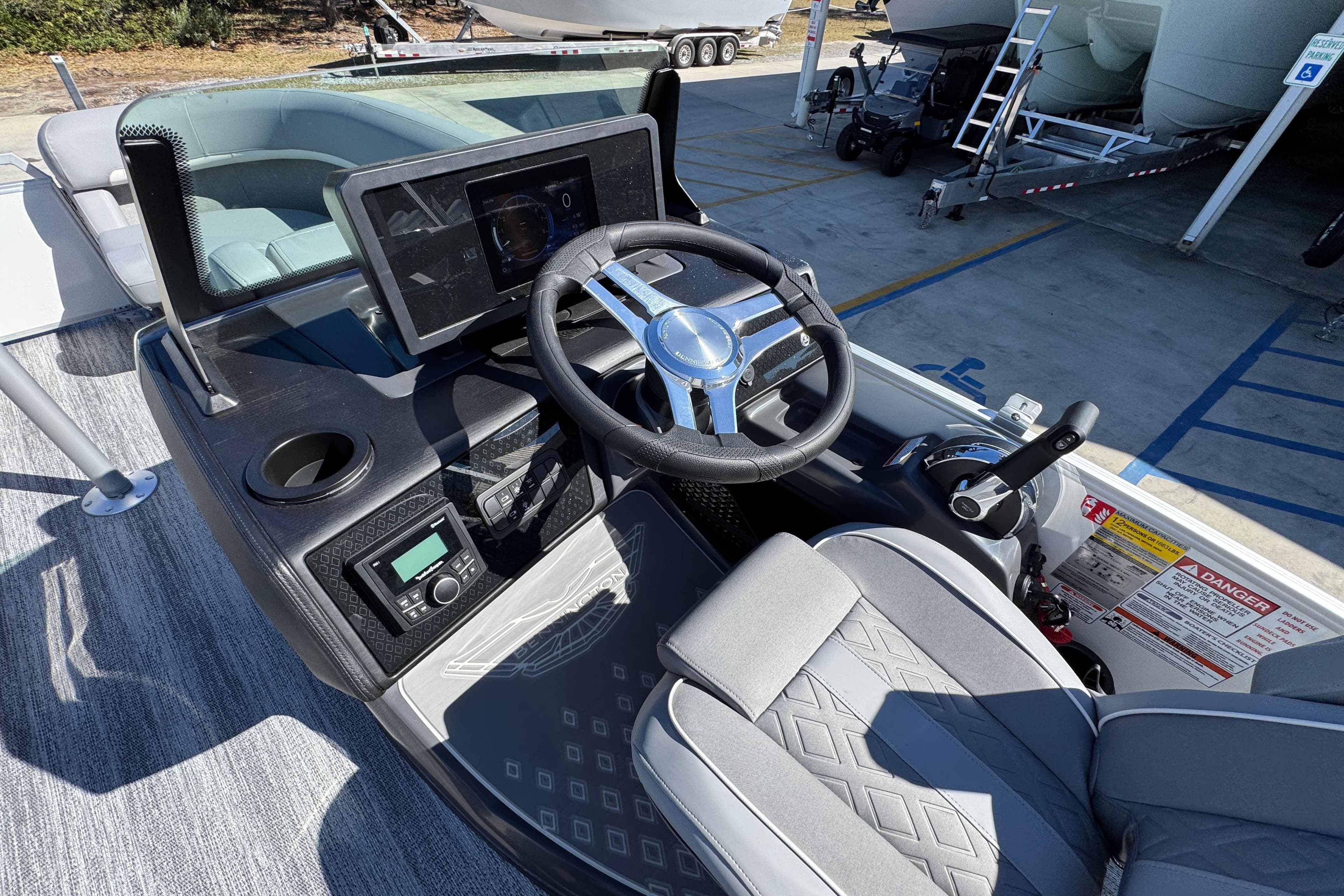 2026 Bennington 22 MSB boat dashboard with steering wheel and control panel.