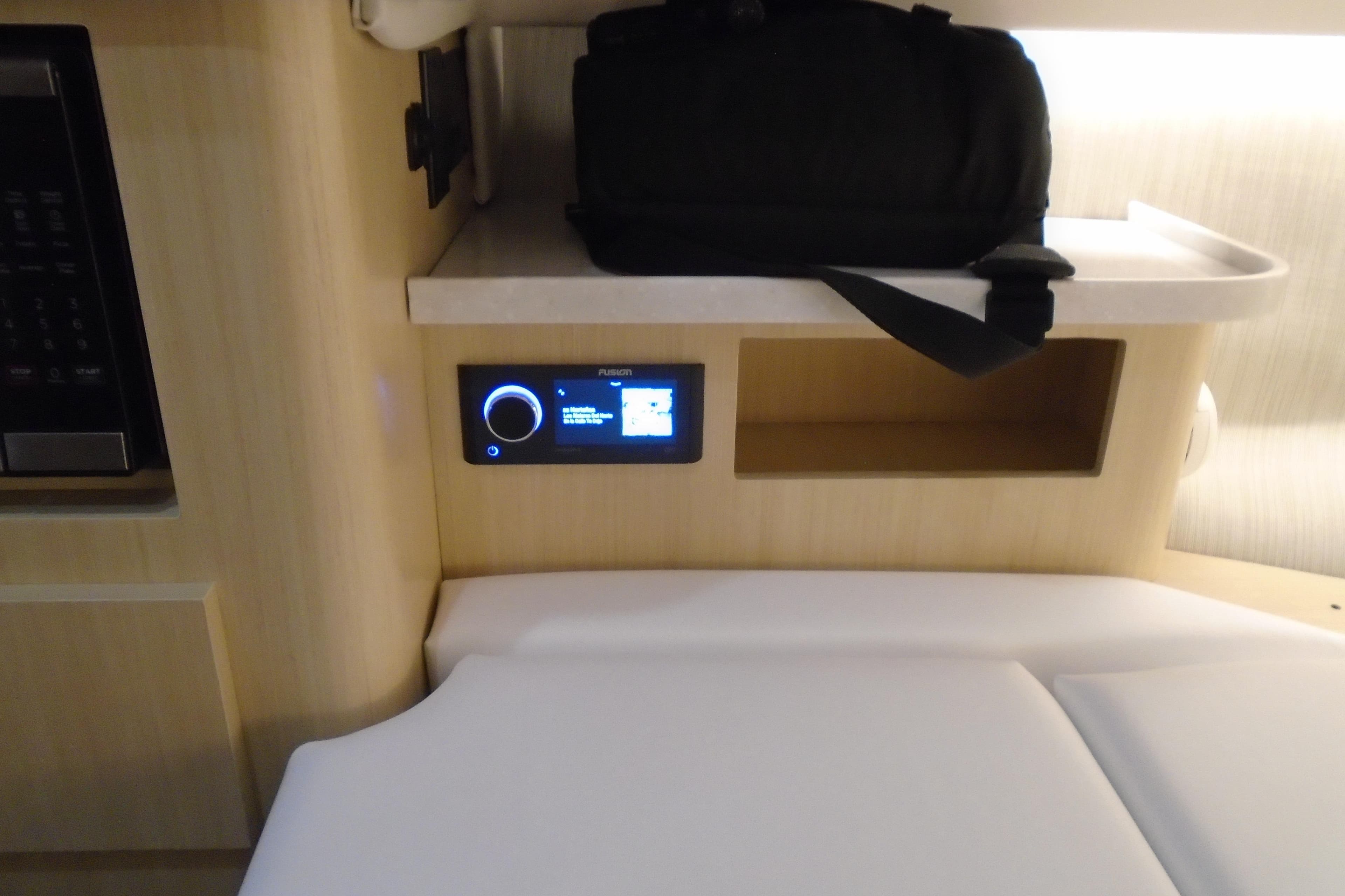Interior of 2026 Regal 38 SAV boat with control panel and storage shelf.